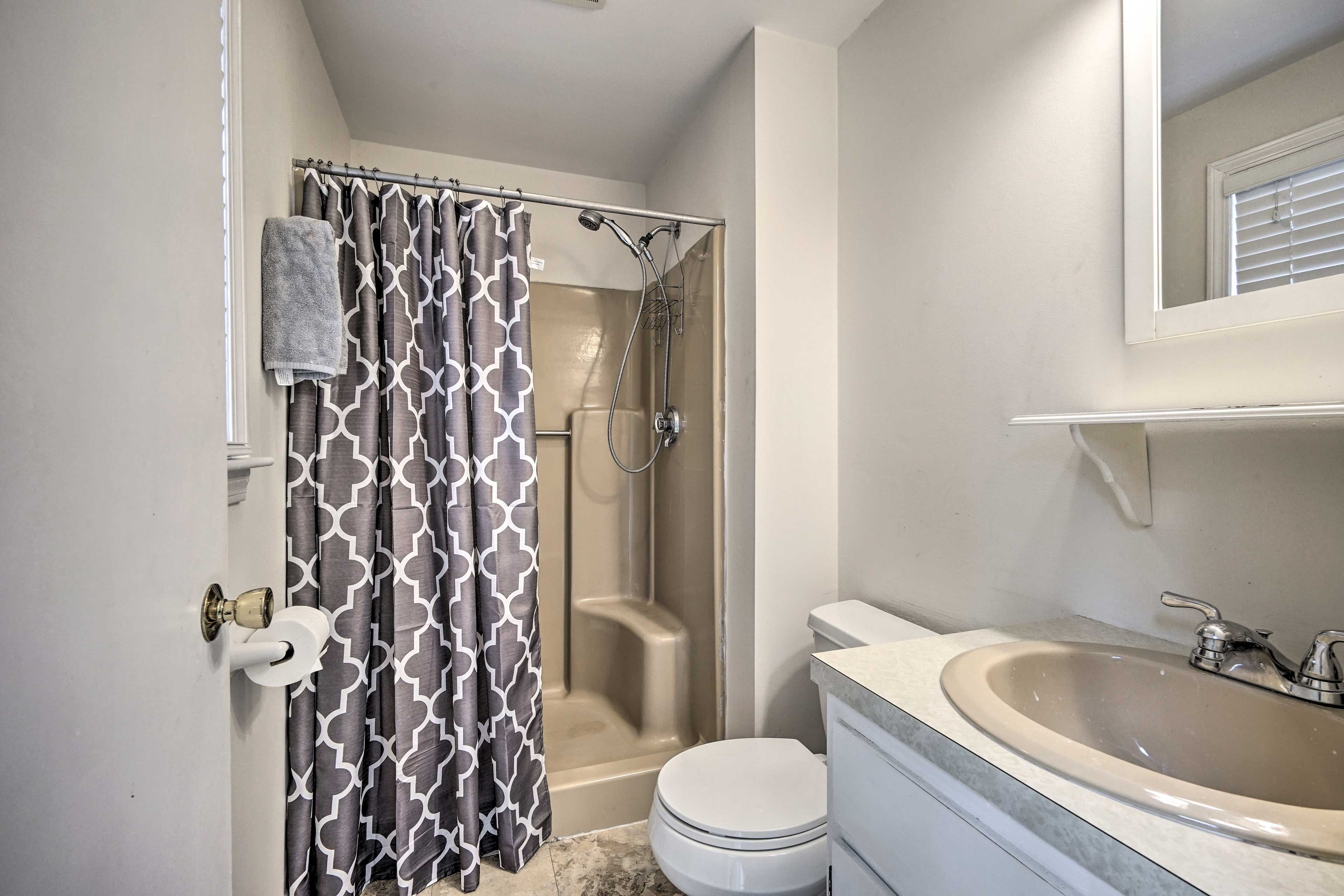 This full en-suite bathroom offers a walk-in shower.