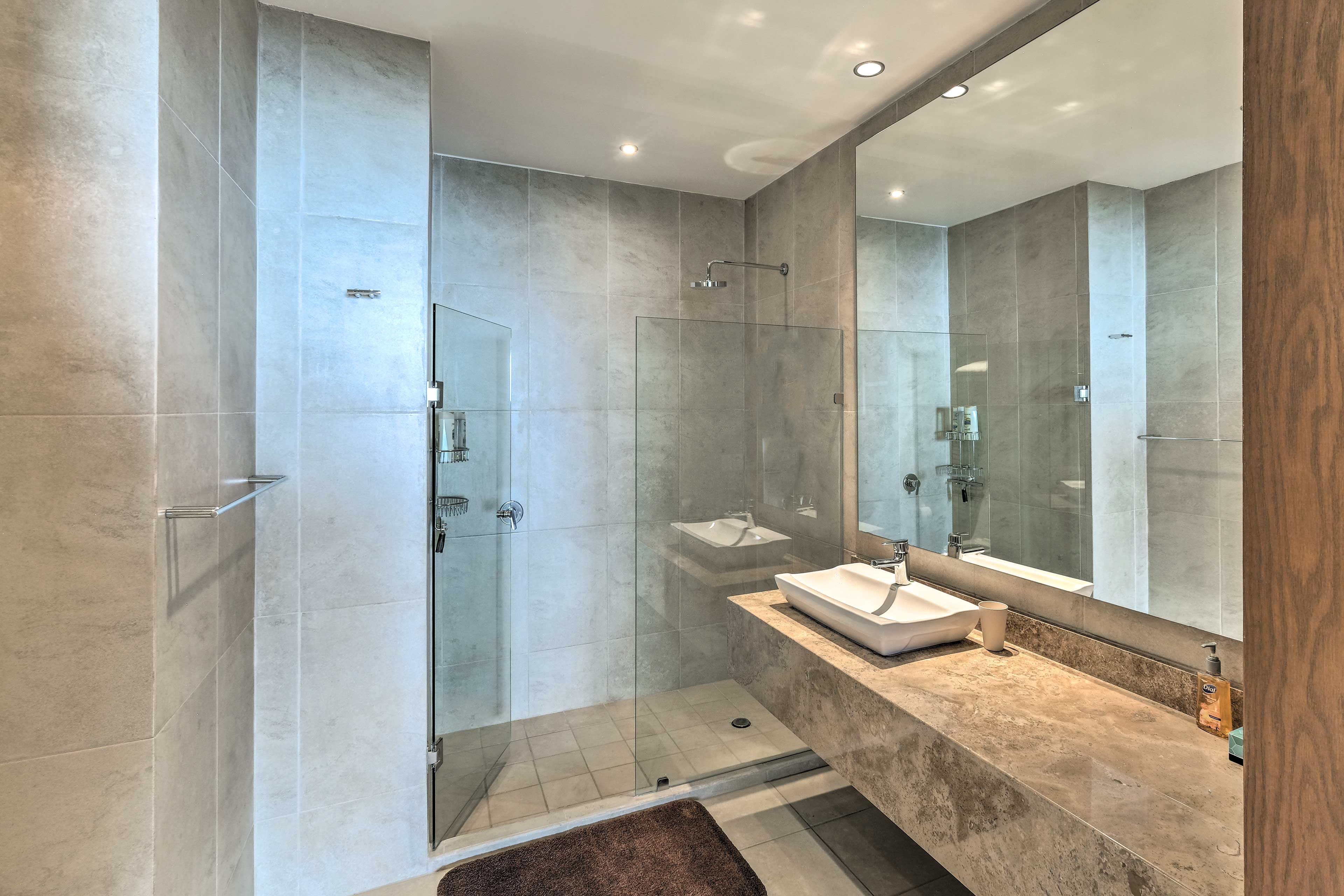 Step into the walk-in shower to wash the sand from between your toes.