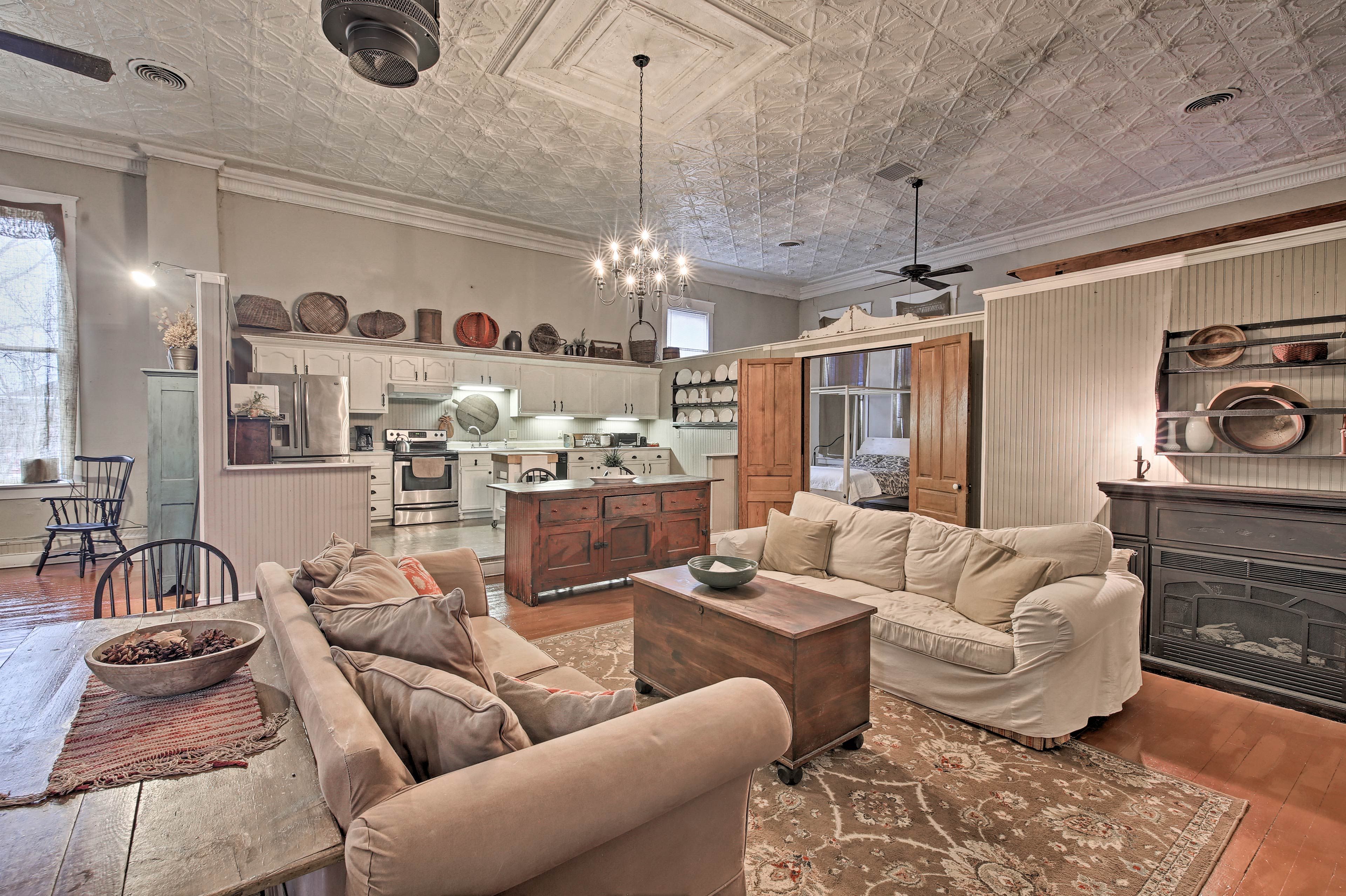 A 3-person dining table is behind one of the sofas, perfect for snacks.
