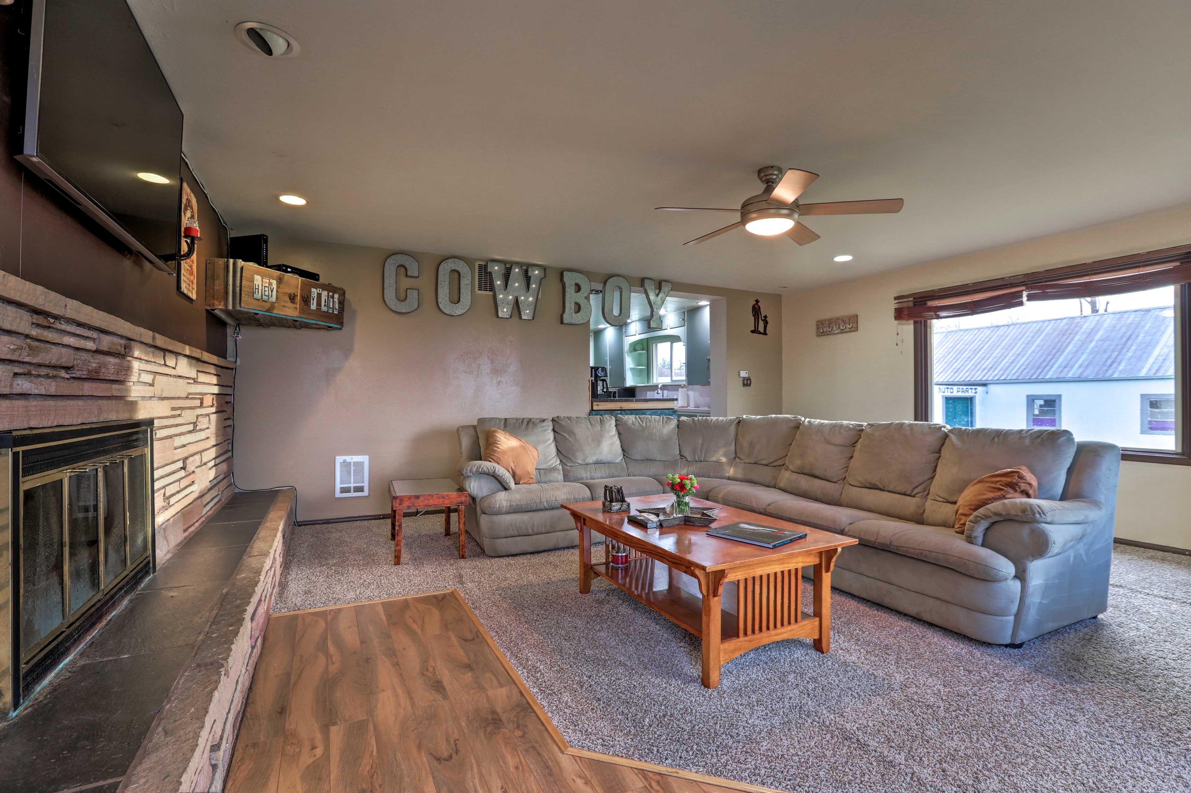 Lounge around on the L-shaped couch in the southwestern-themed living room.