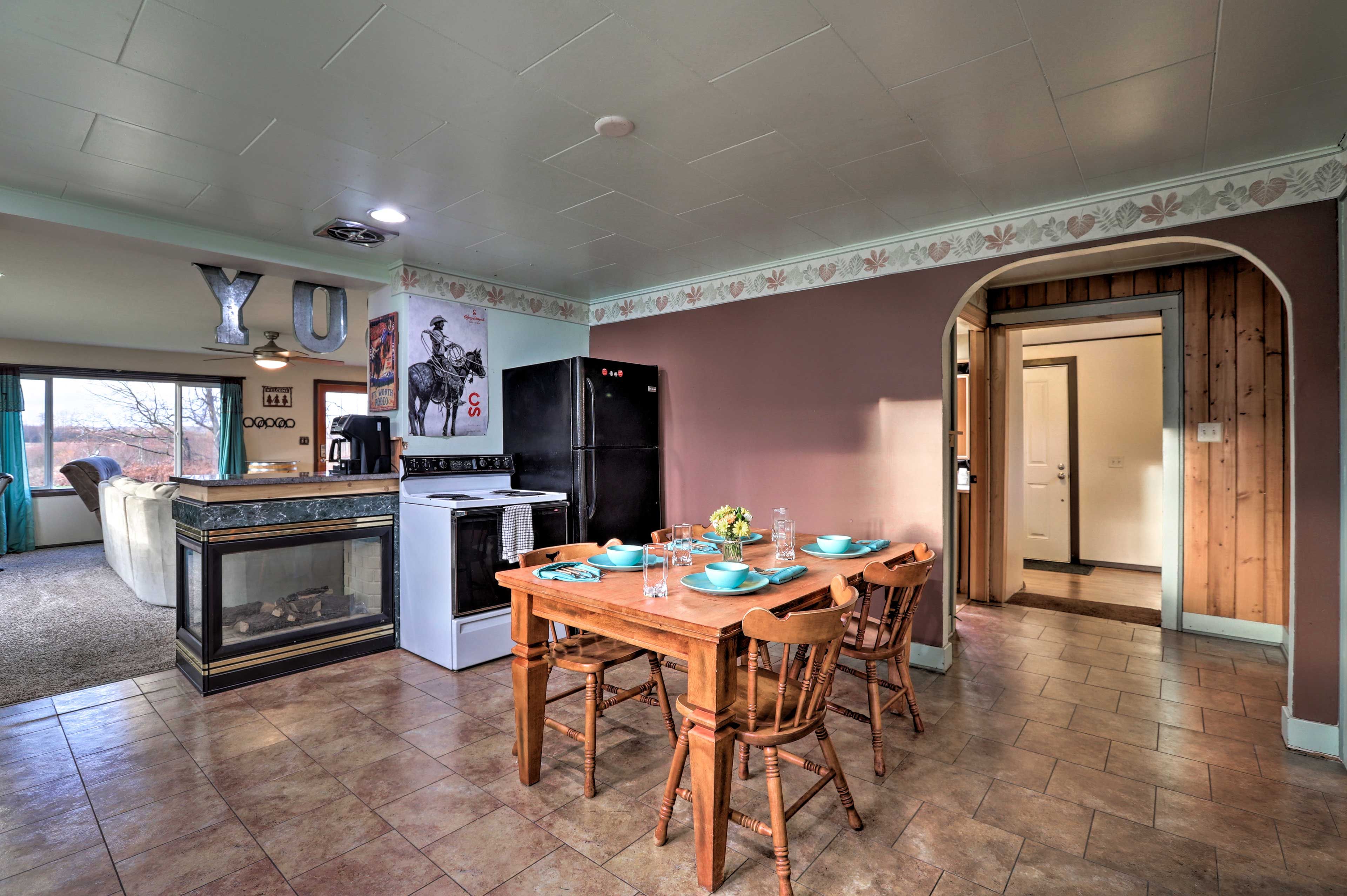 Serve meals at the dining table set for 4 in the kitchen.