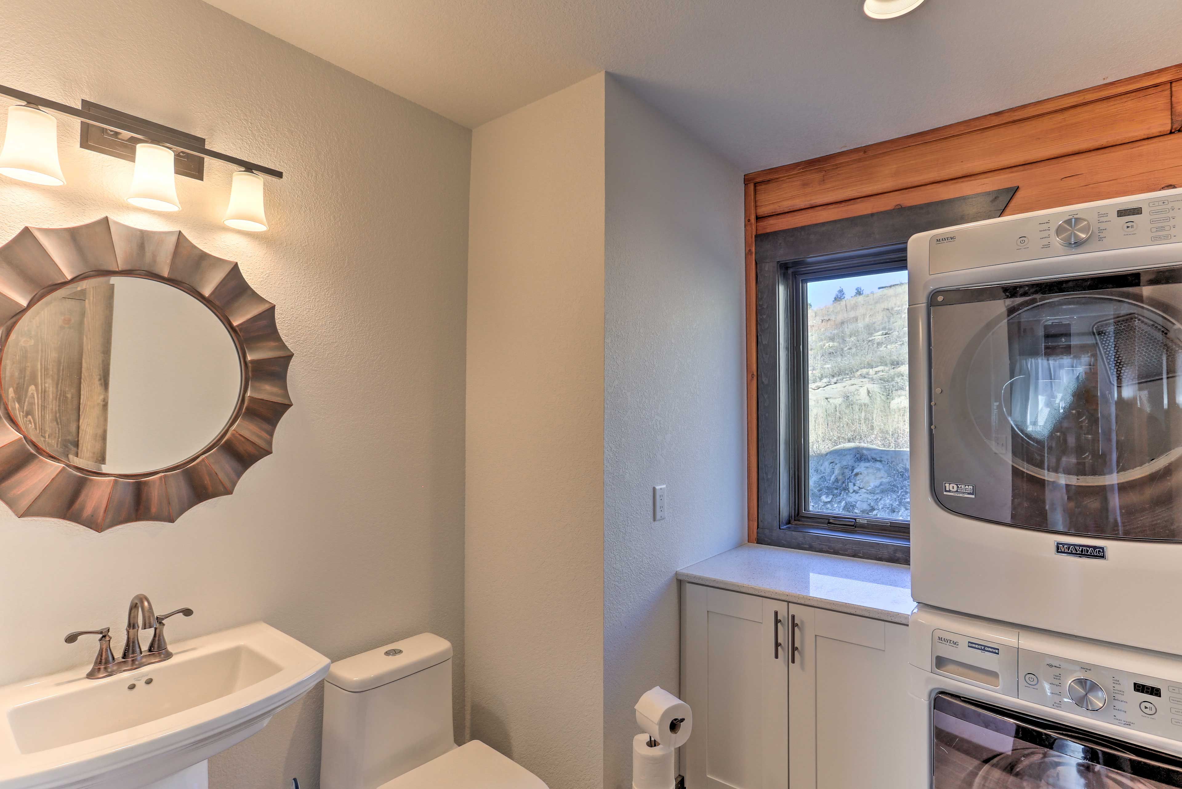 This half bathroom also serves as a laundry room!