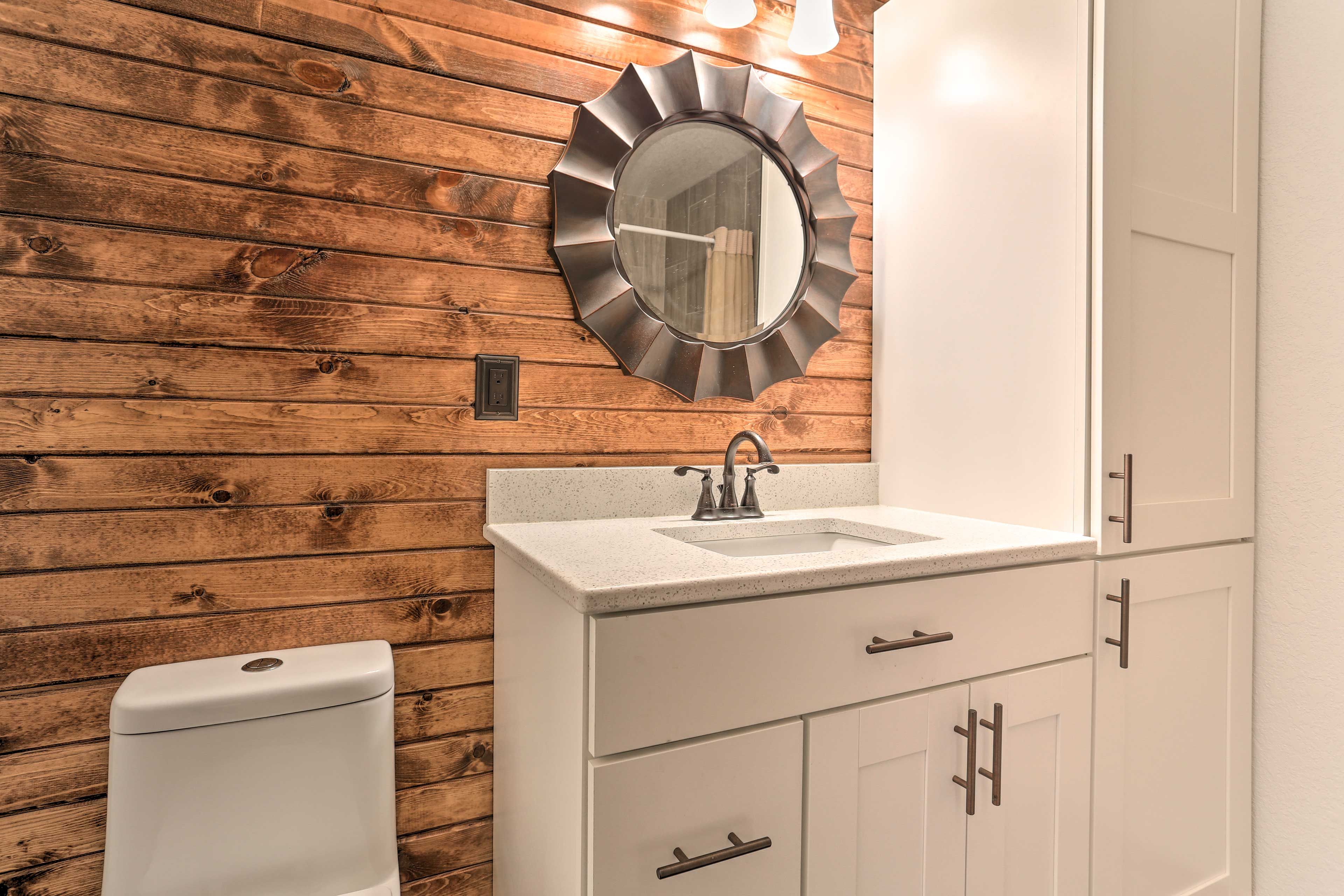 This full bathroom offers plenty of storage space.