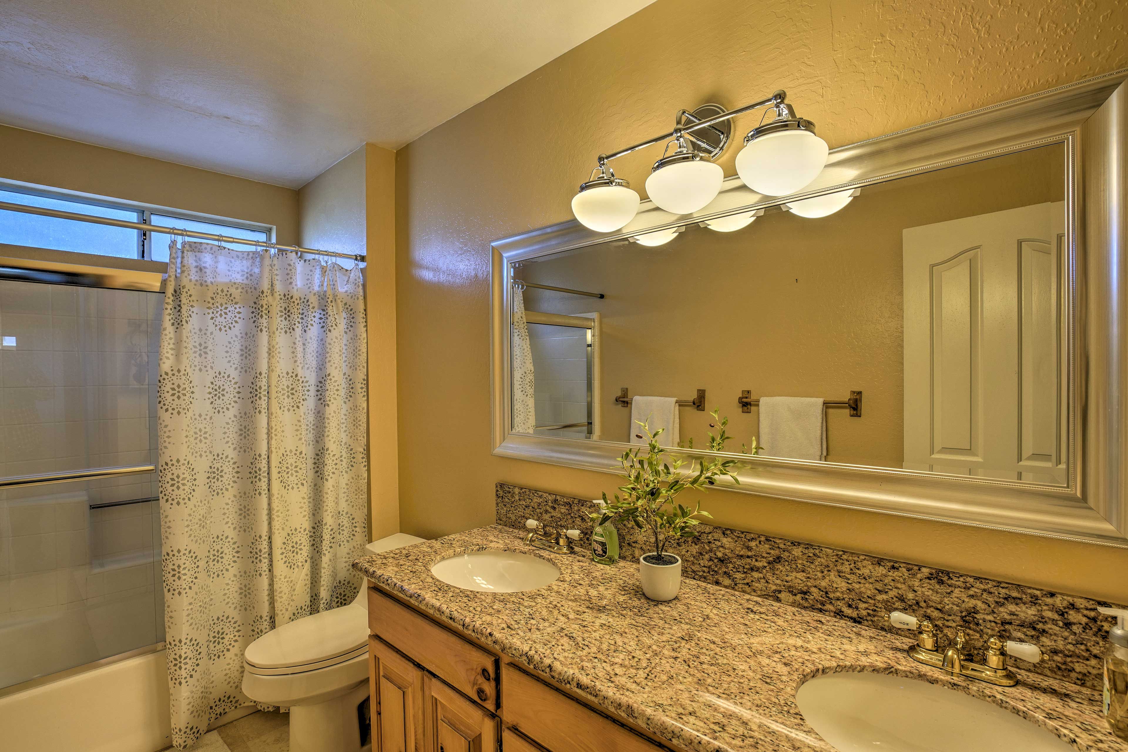 Enjoy the convenience of dual sinks and a large mirror in this bathroom.