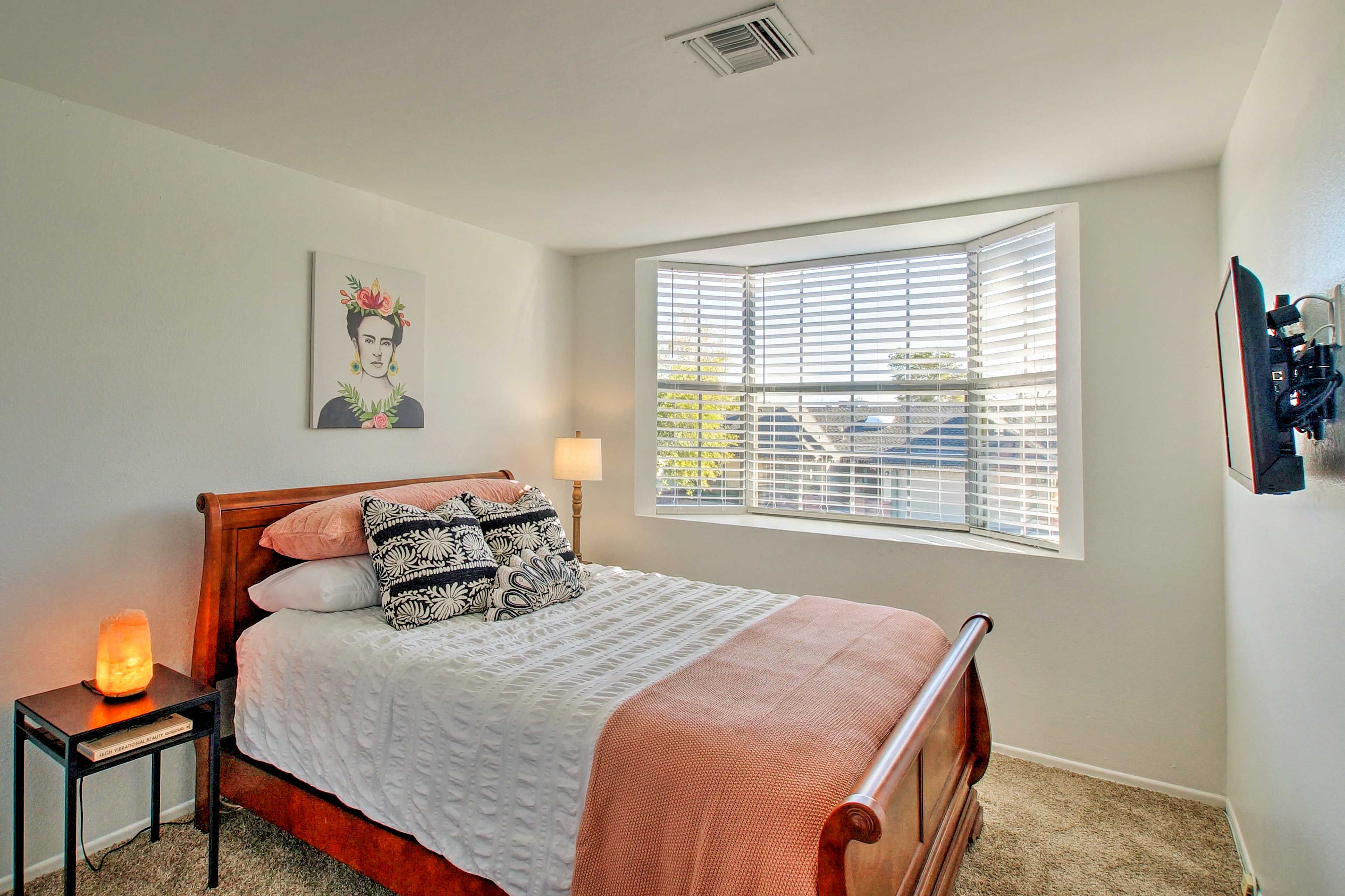 The second bedroom comfortably sleeps 2 on its queen bed.