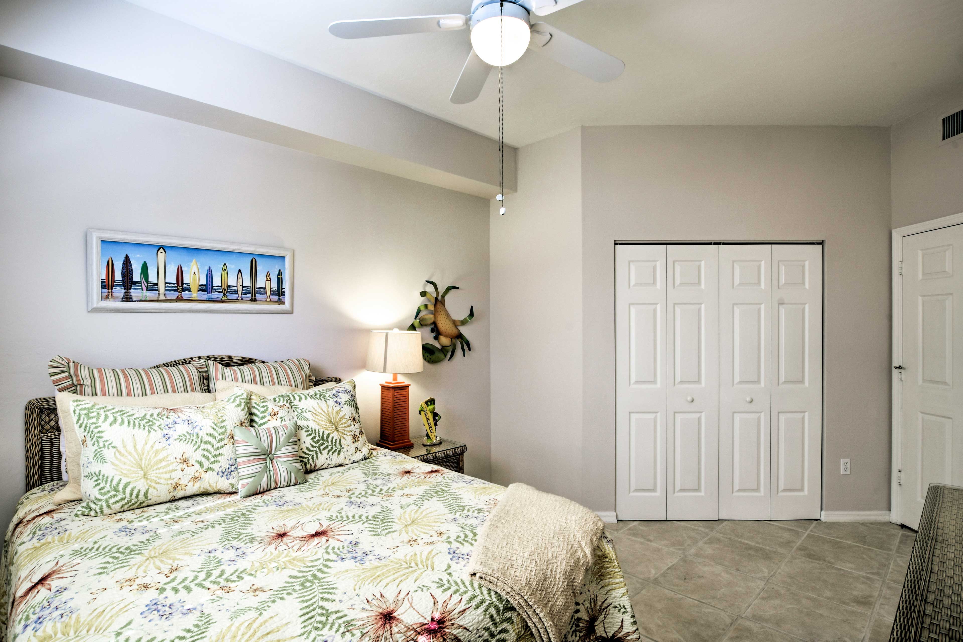 The 2nd bedroom includes a queen-sized bed and tropical decor!