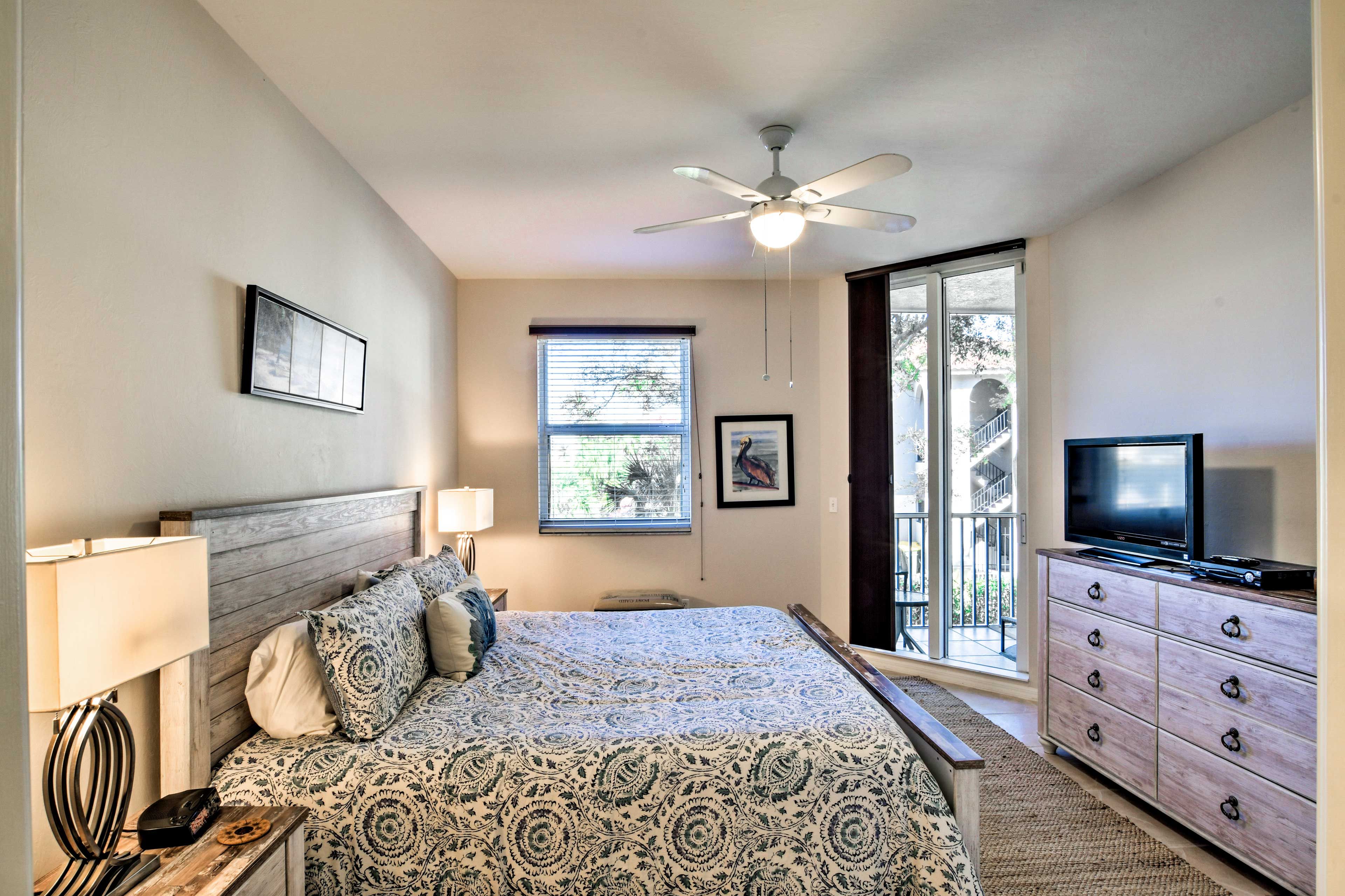 The bedroom suite features a king bed, flat-screen TV & private patio entrance.