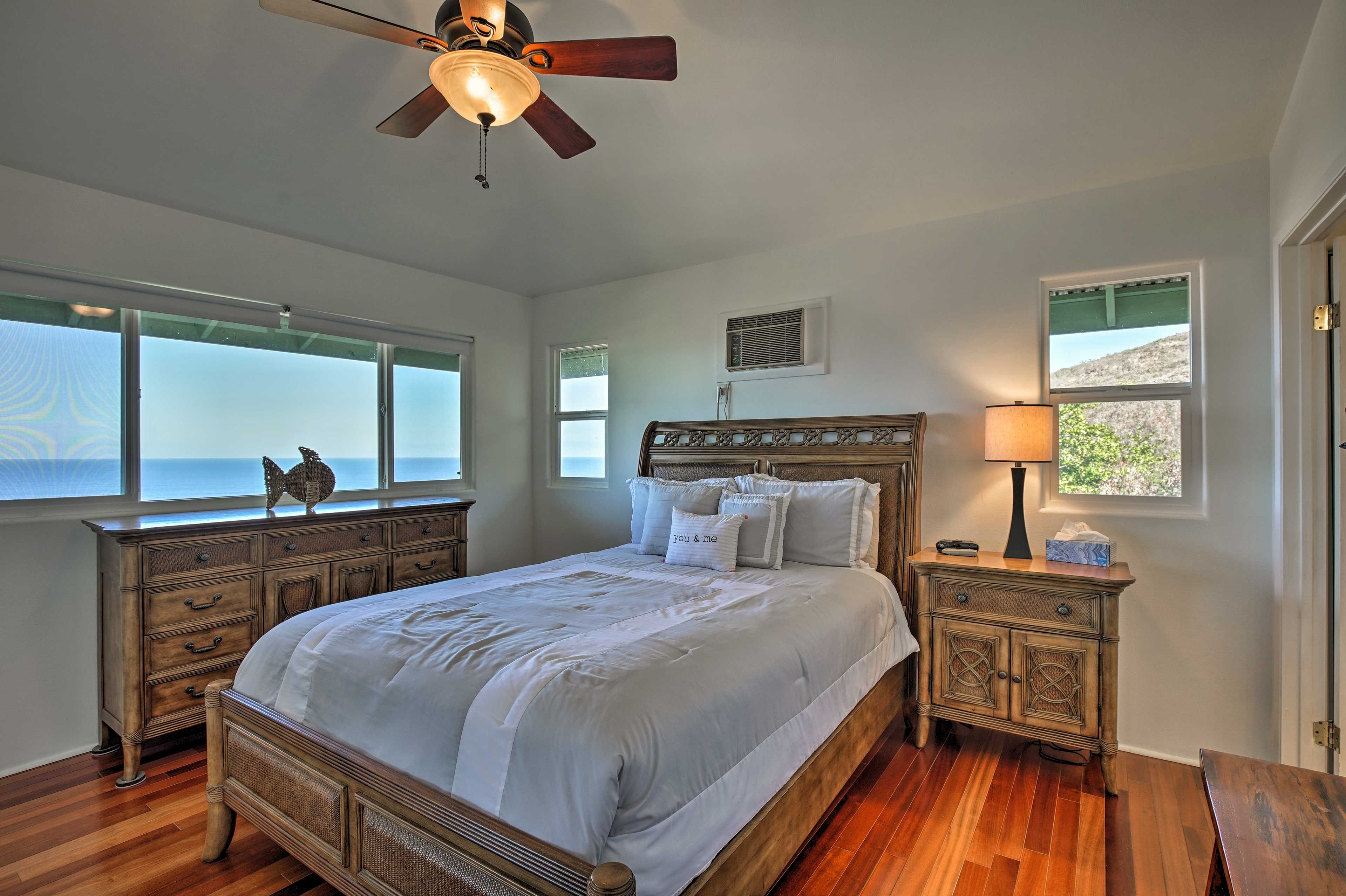 The bedroom suite boasts a luxurious queen bed.