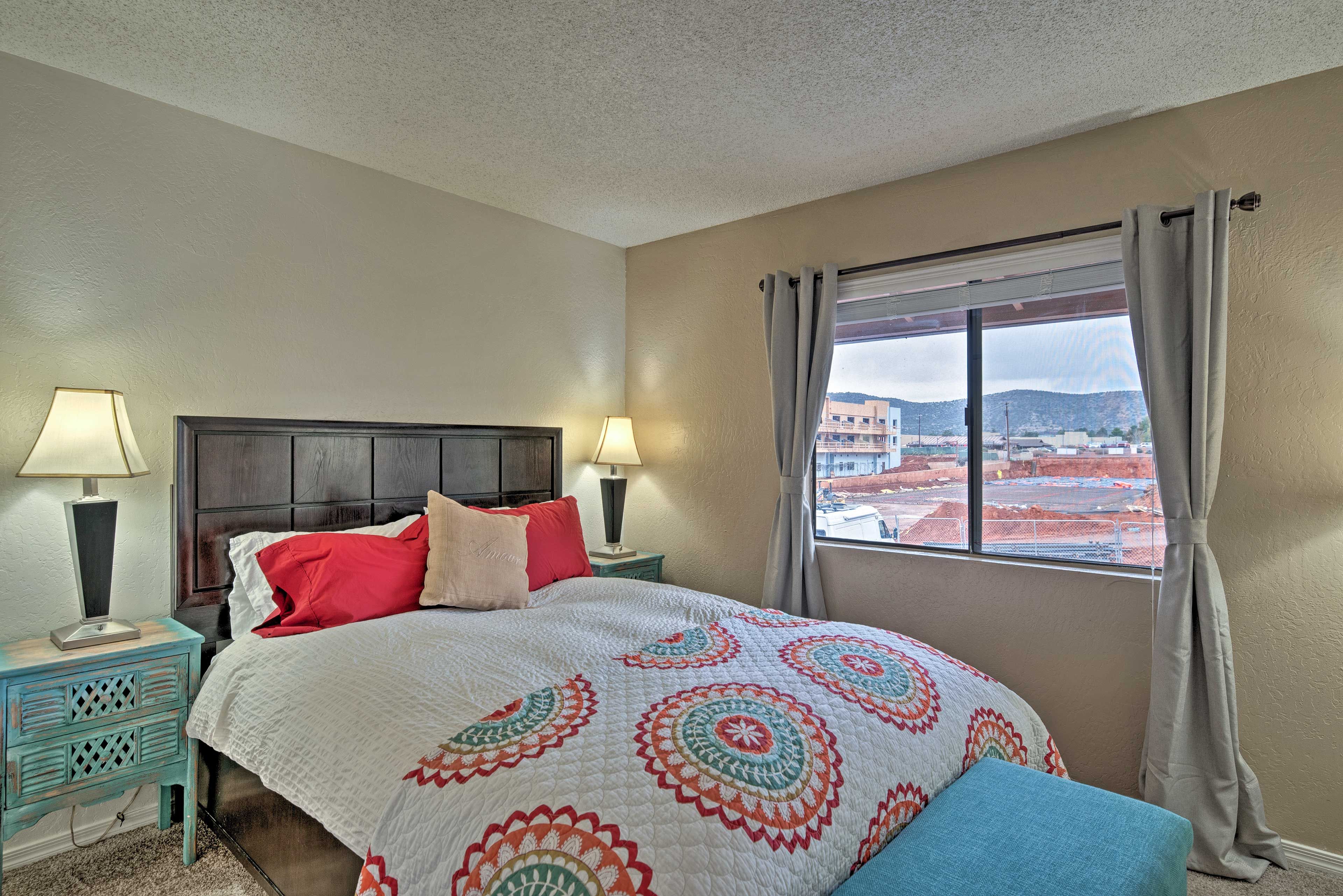 The 2nd bedroom's queen-sized bed overlooks the mountainous landscape.