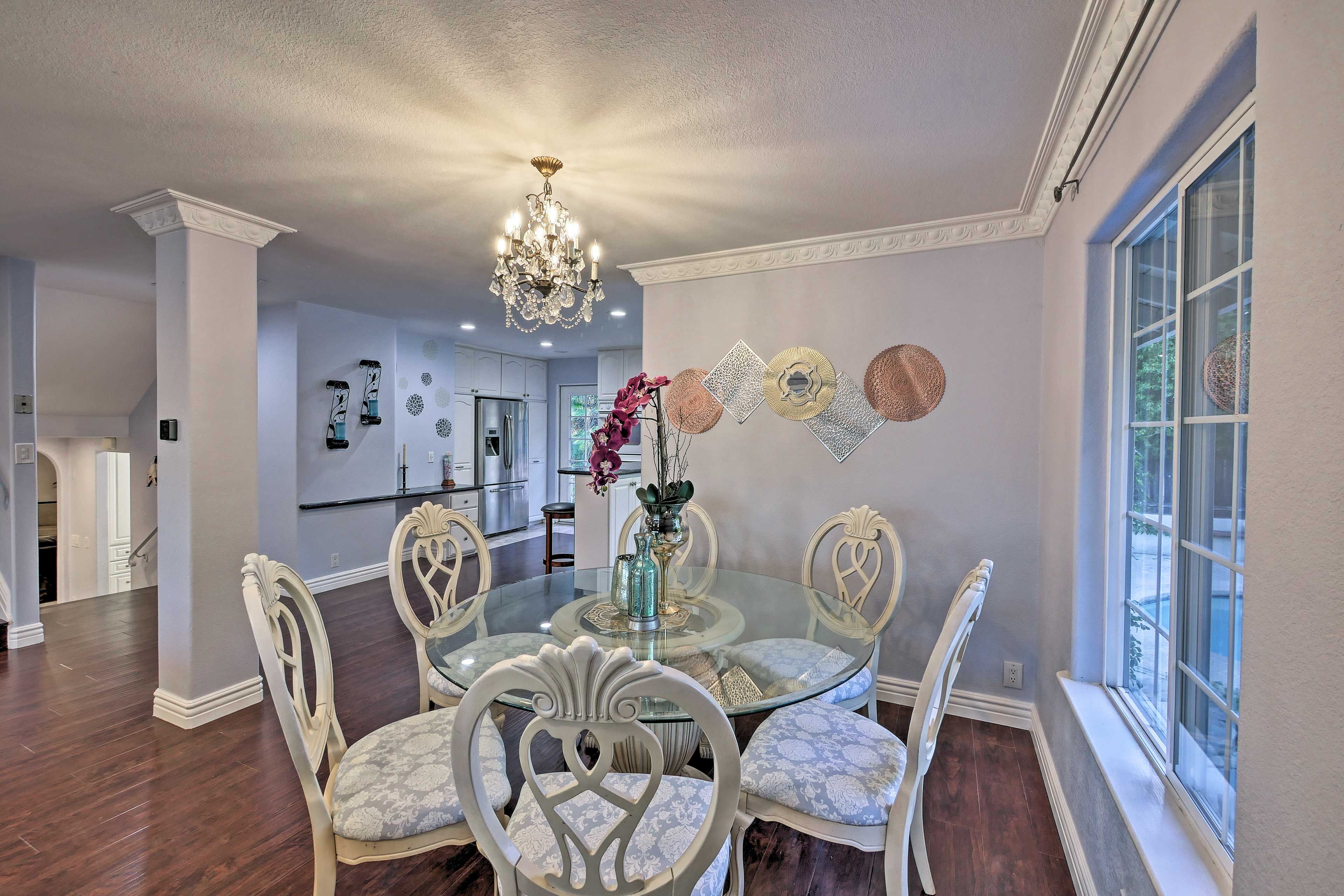 Serve dinner beneath the grand chendelier at the 6-seat dining table.
