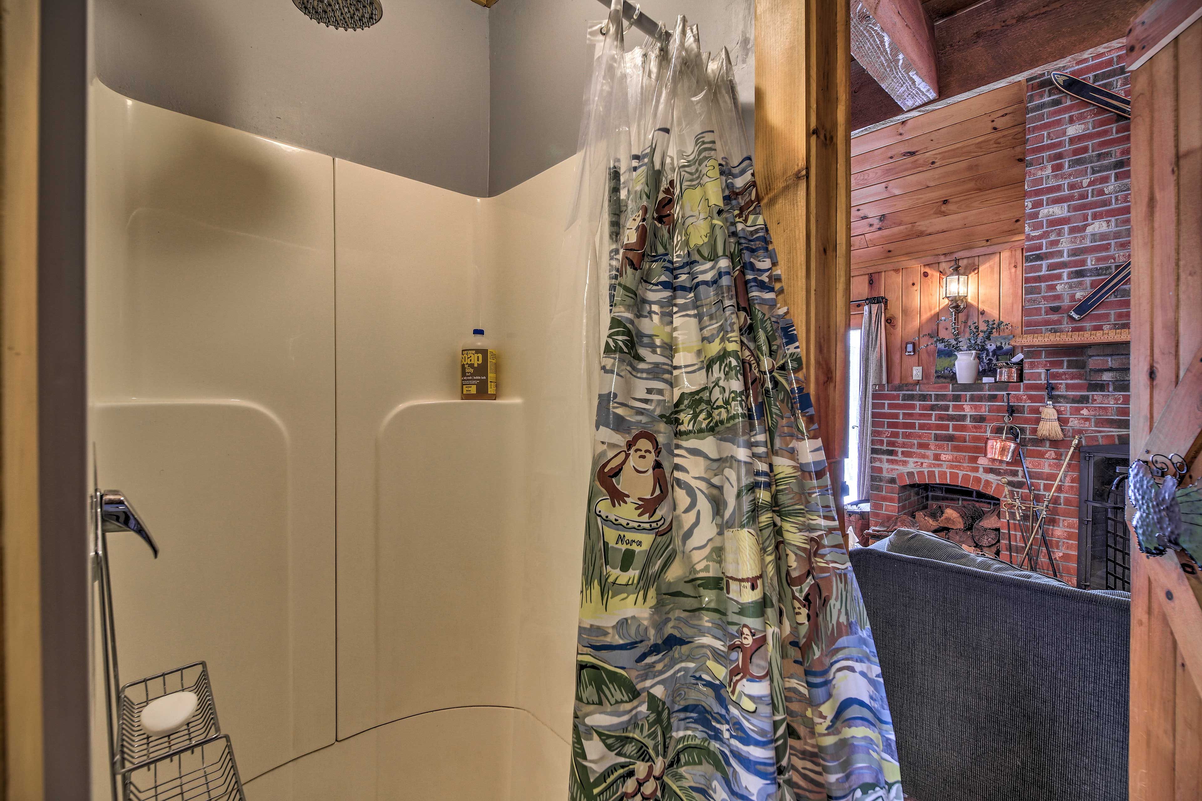 The bathroom is located just past the main living area.