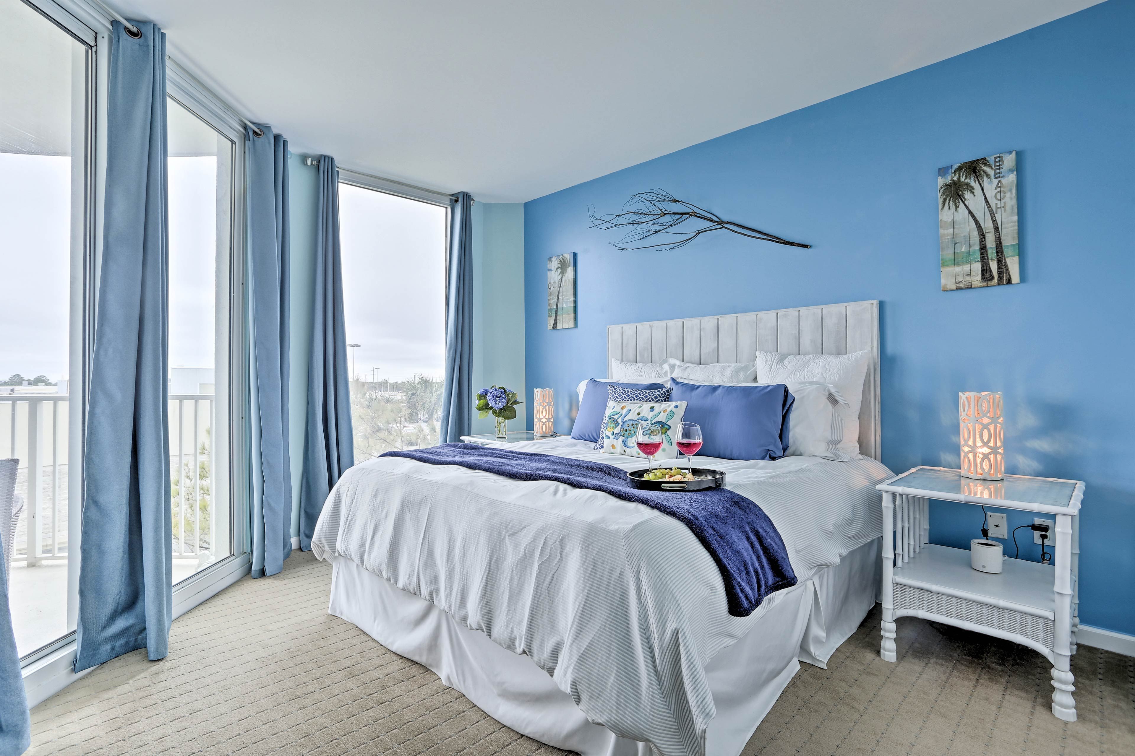 A wall of windows illuminates this bedroom's king-sized bed.