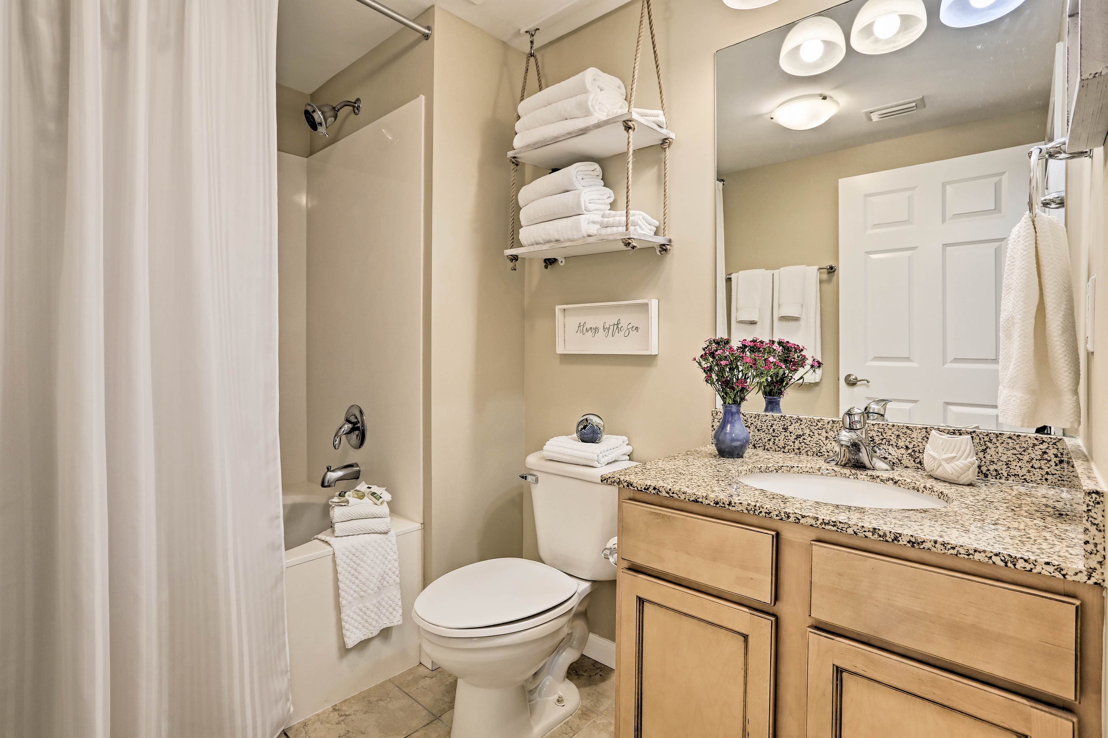 The en-suite bathroom includes a shower/tub combo and fresh towels.