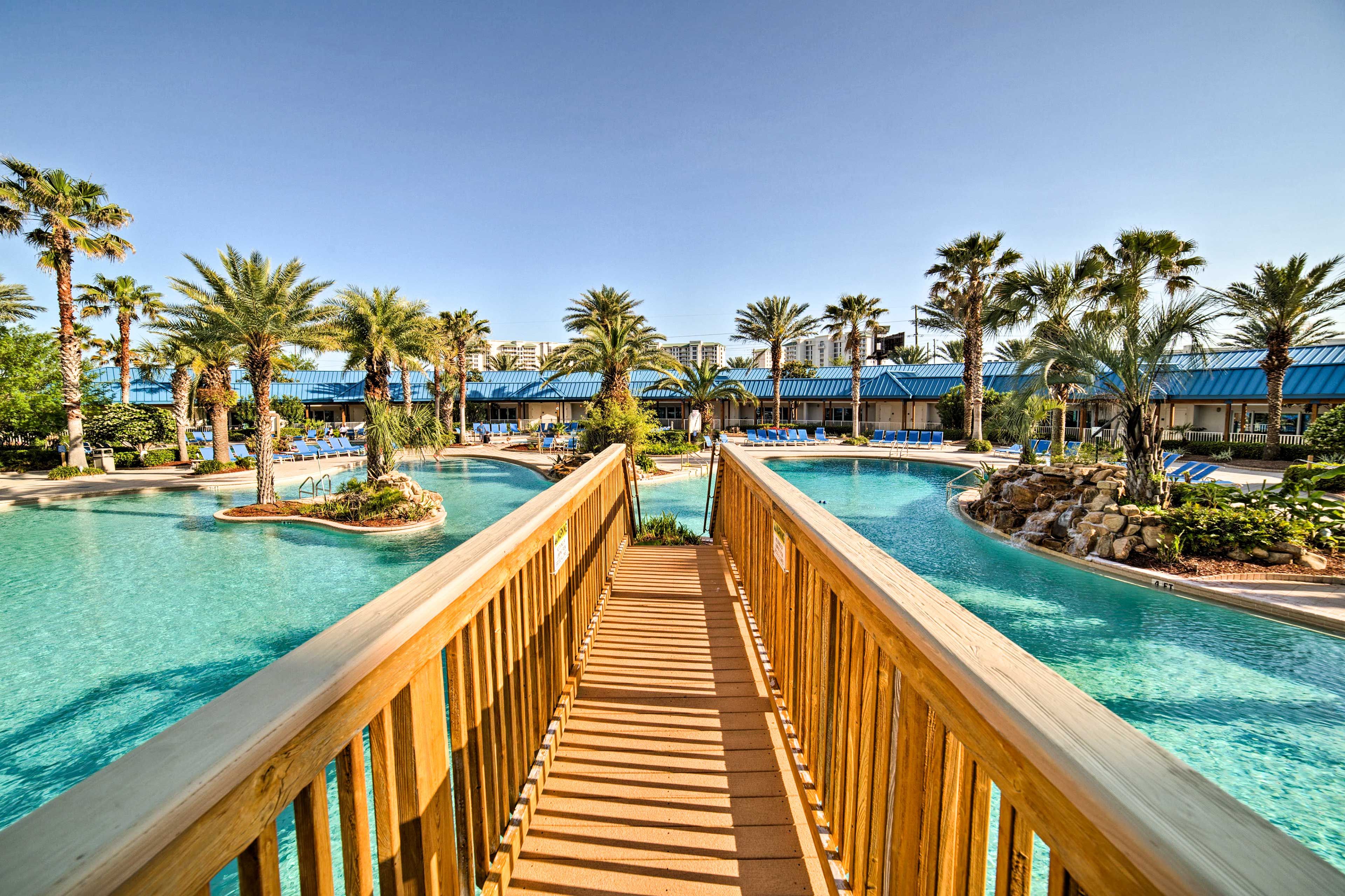 A wooden boardwalk leads to the heart of the huge community pool!