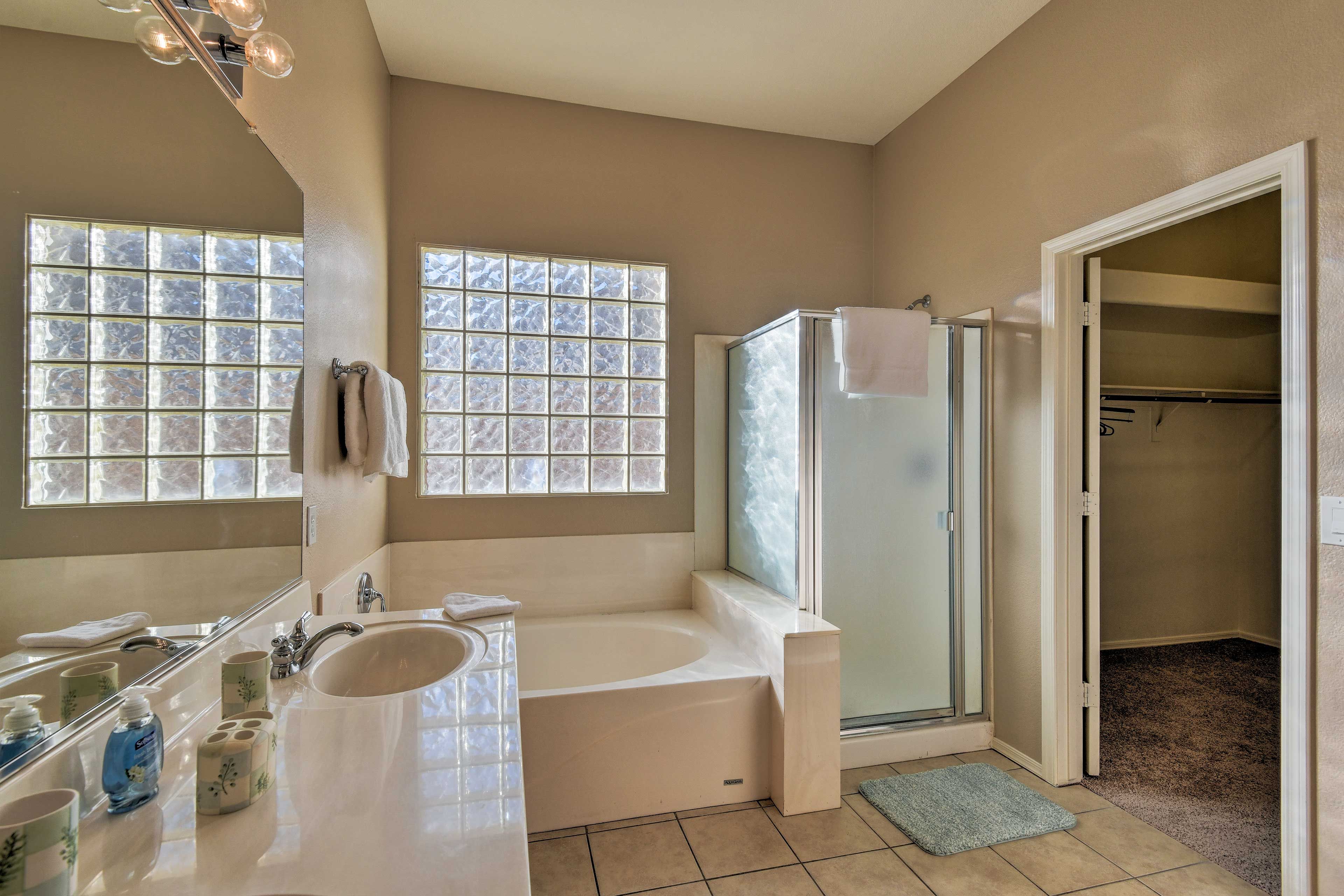 Take a relaxing soak in the large bathtub.