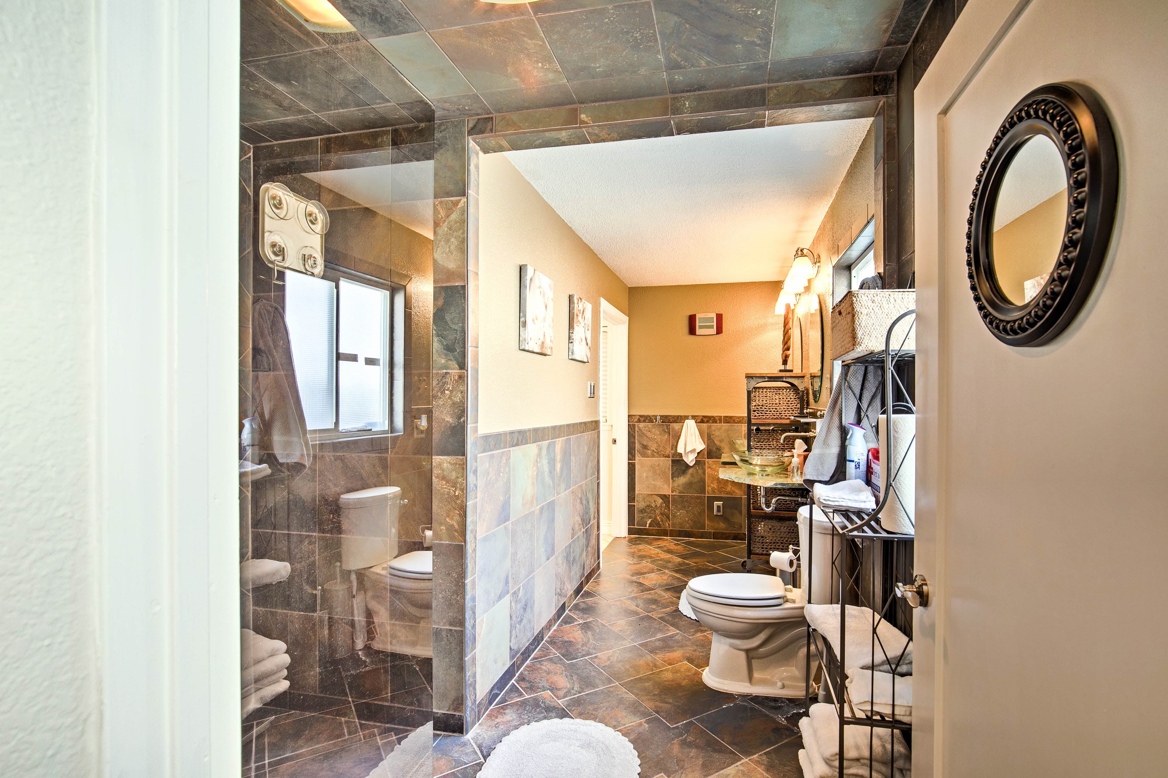This luxury bathroom features a walk-in shower and gorgeous tile work.
