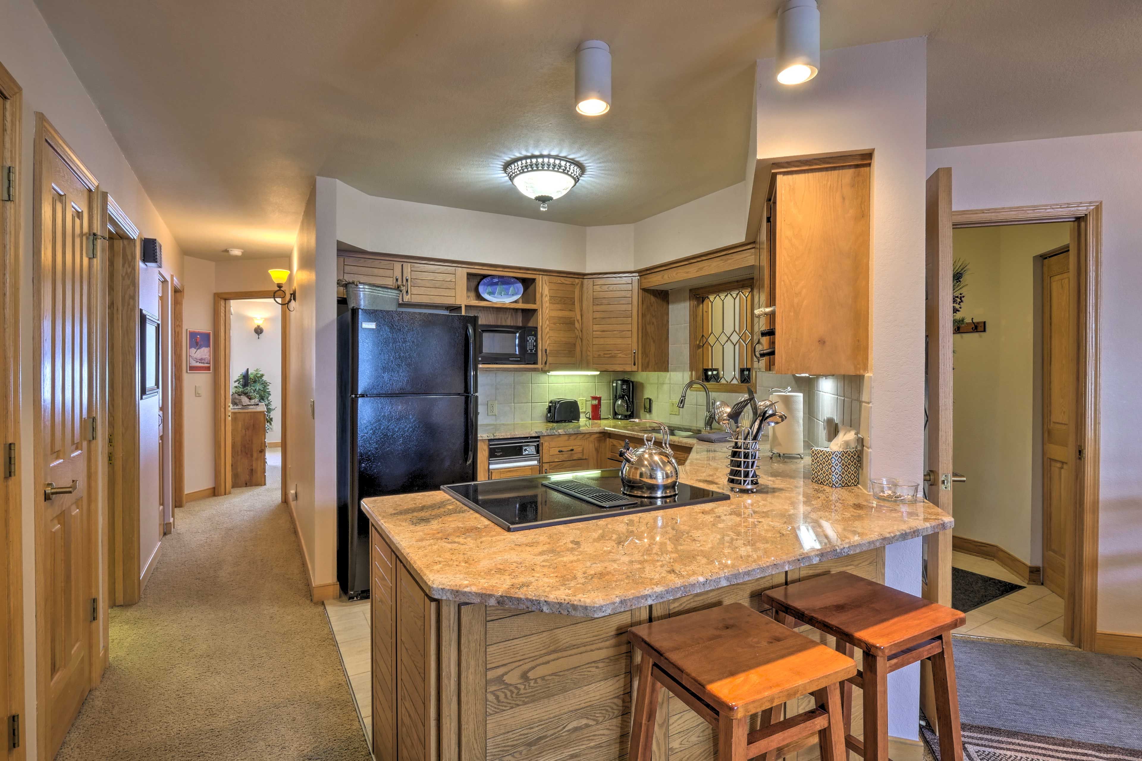 The kitchen comes fully equipped with sleek countertops.