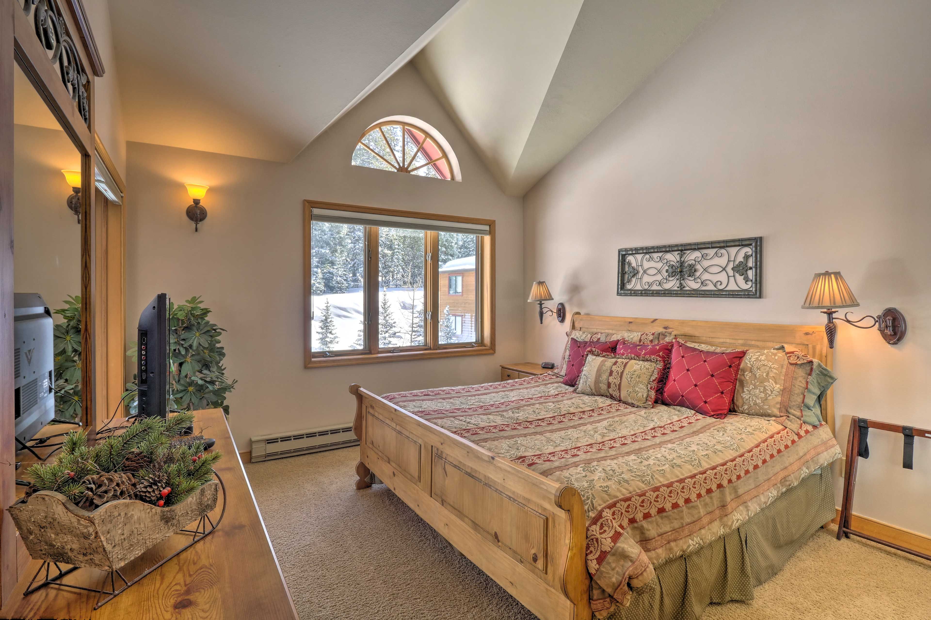 The bedroom suite boasts a luxurious king bed.