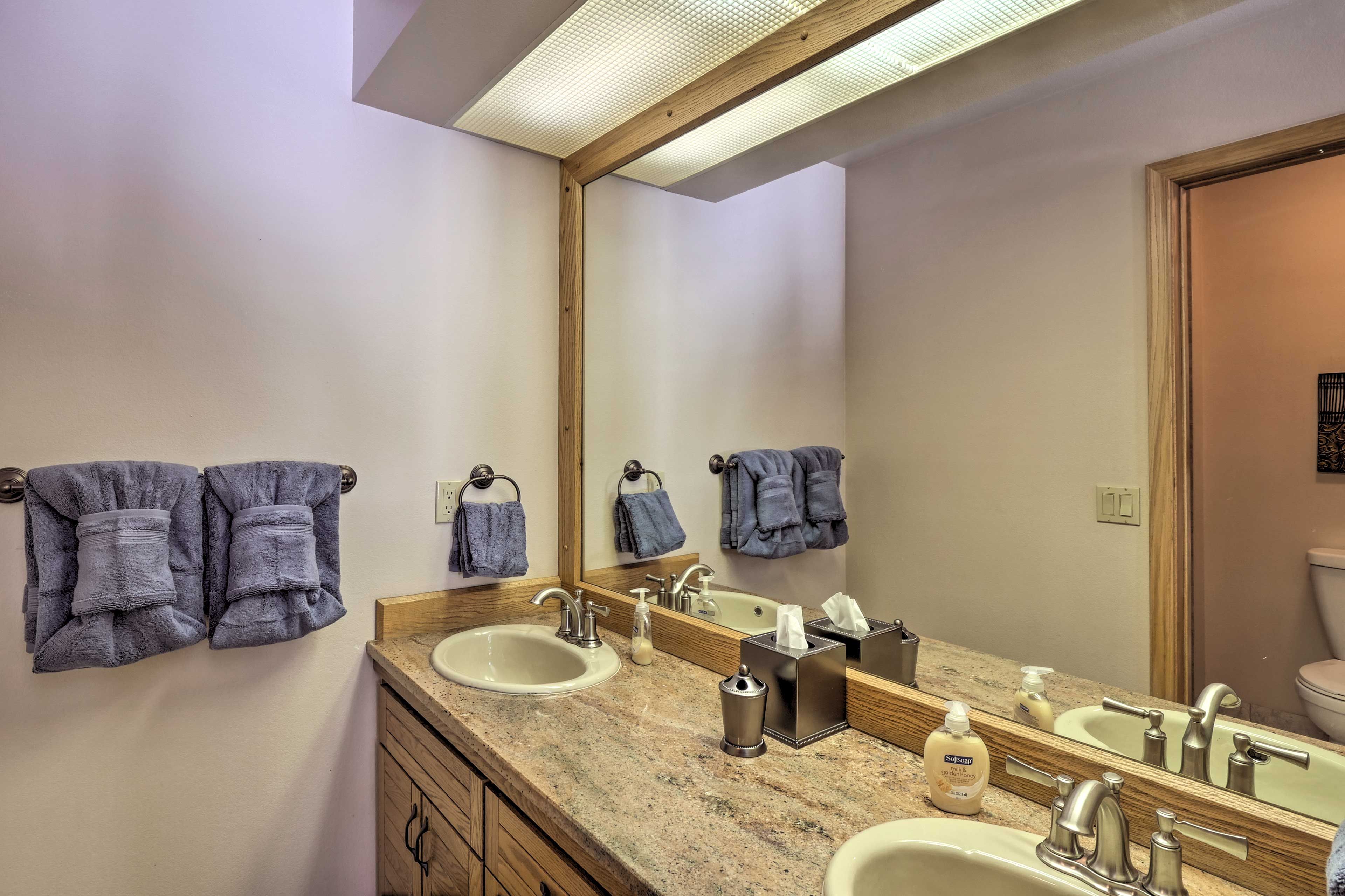 The bedroom suite features an en-suite bathroom with a double sink vanity.