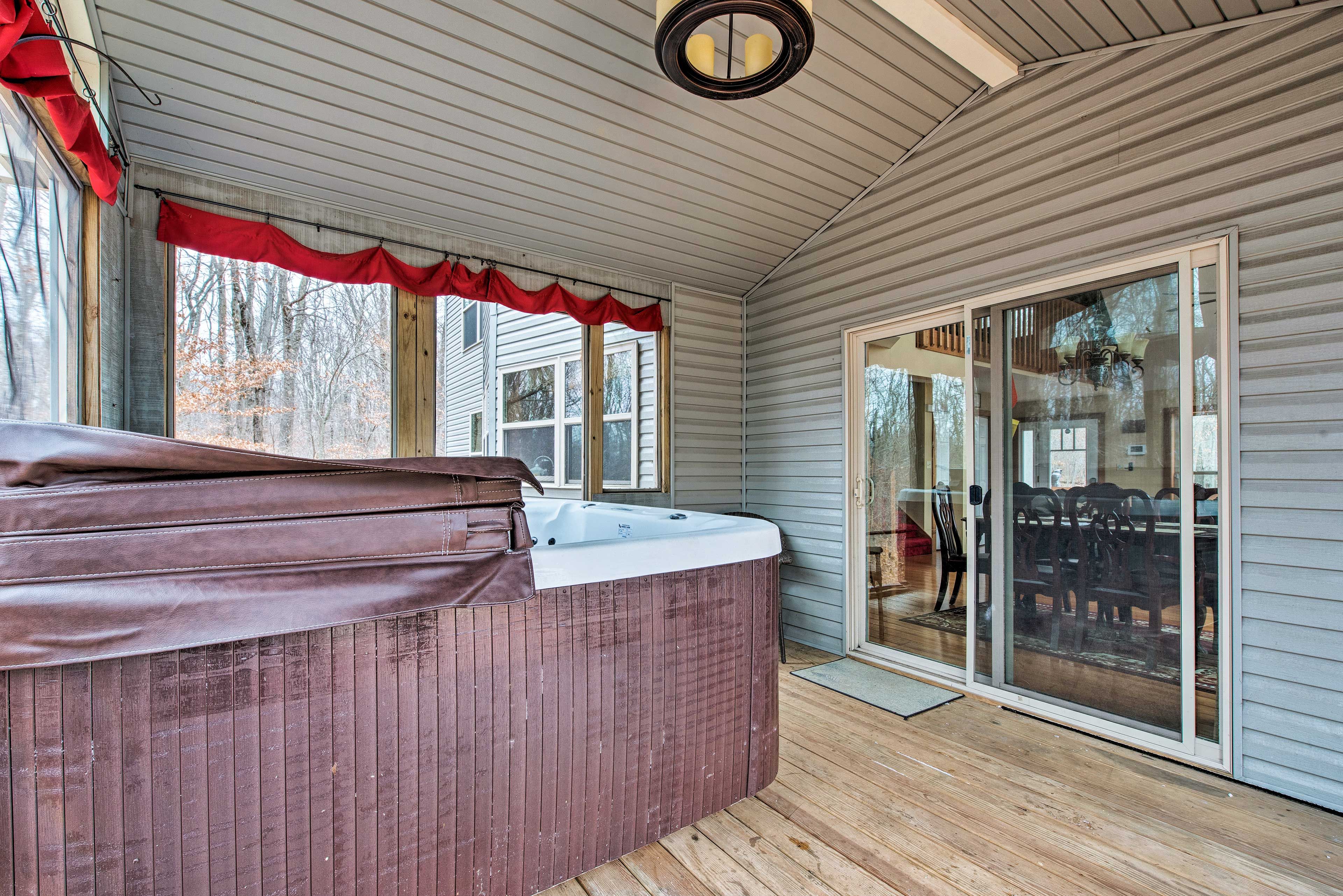 Step out to the screened-in porch to relax in the hot tub.