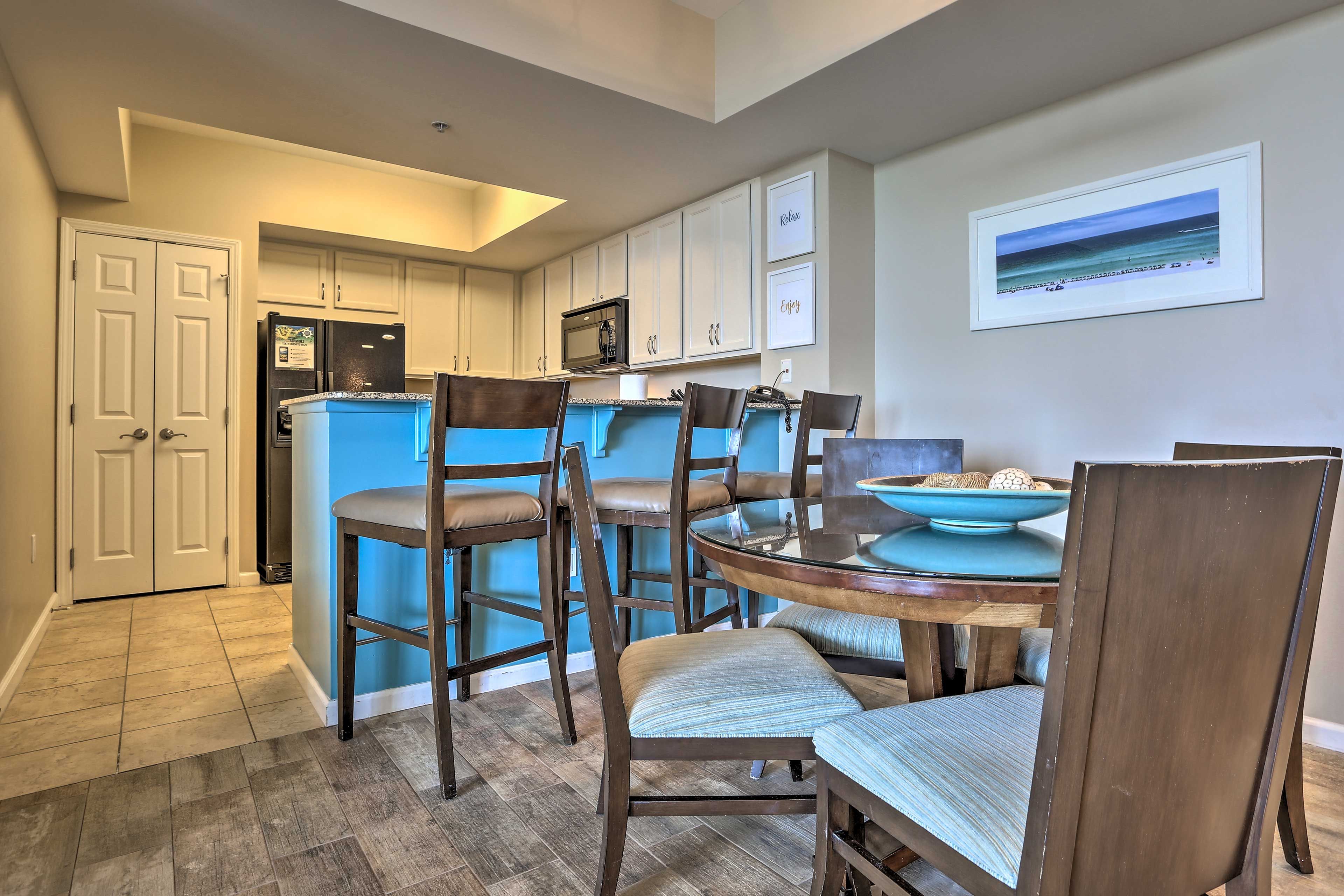 Dine at the 4-person dining table or the 3-person breakfast bar.