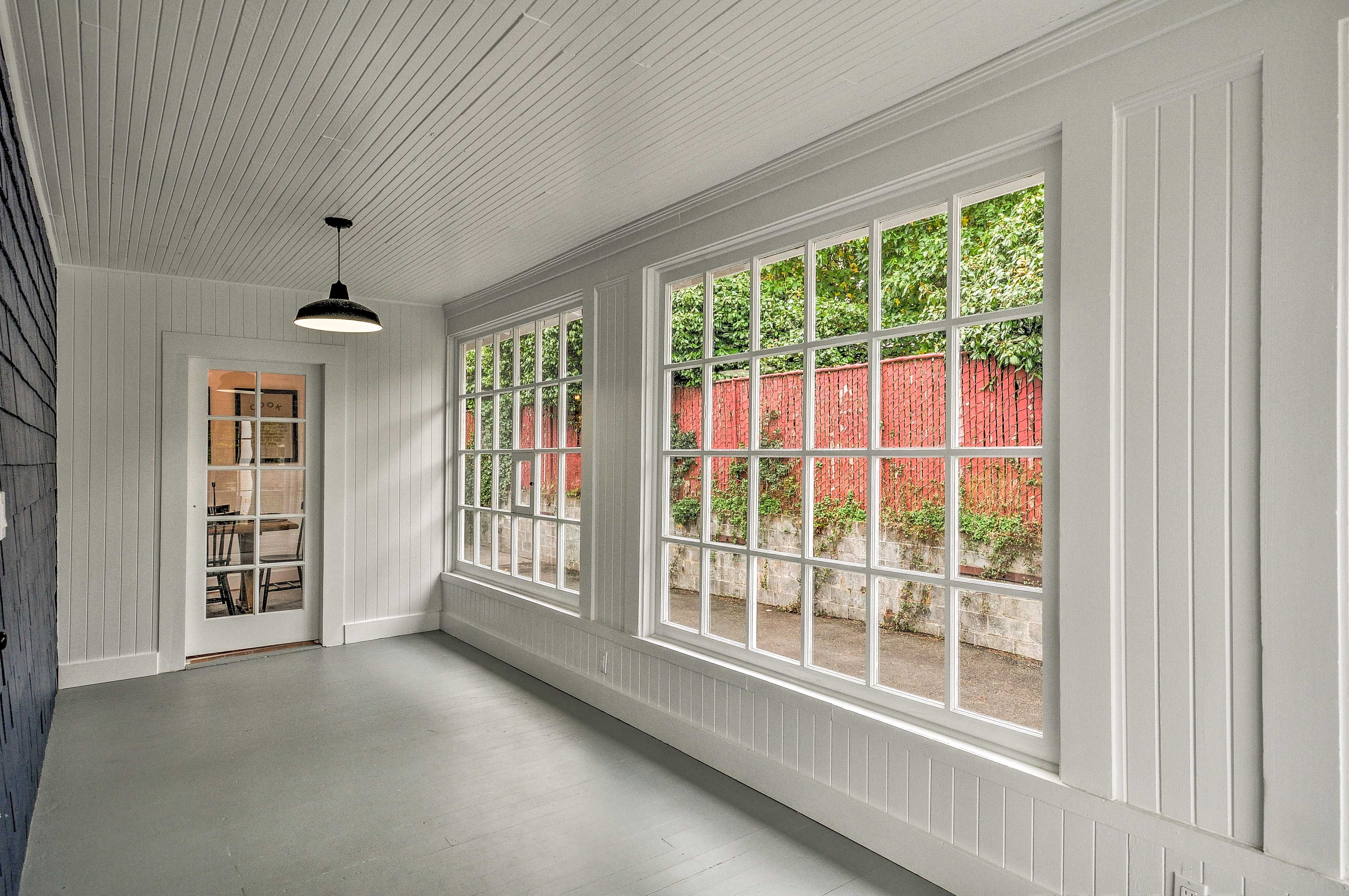 Enjoy peaceful scenery and warm sunlight in this wraparound sunroom.