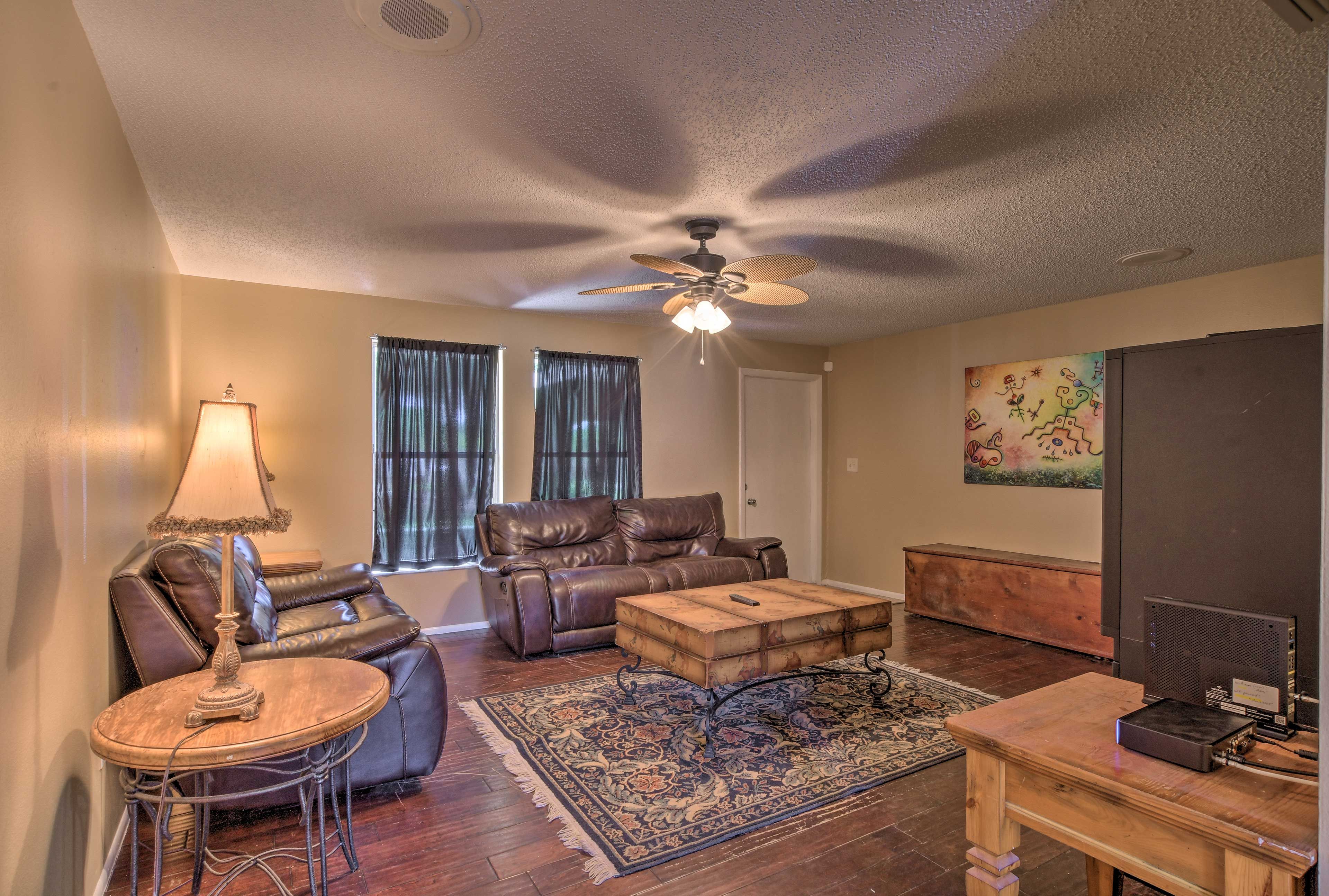 Take a seat in the living room and watch your favorite shows on the TV.