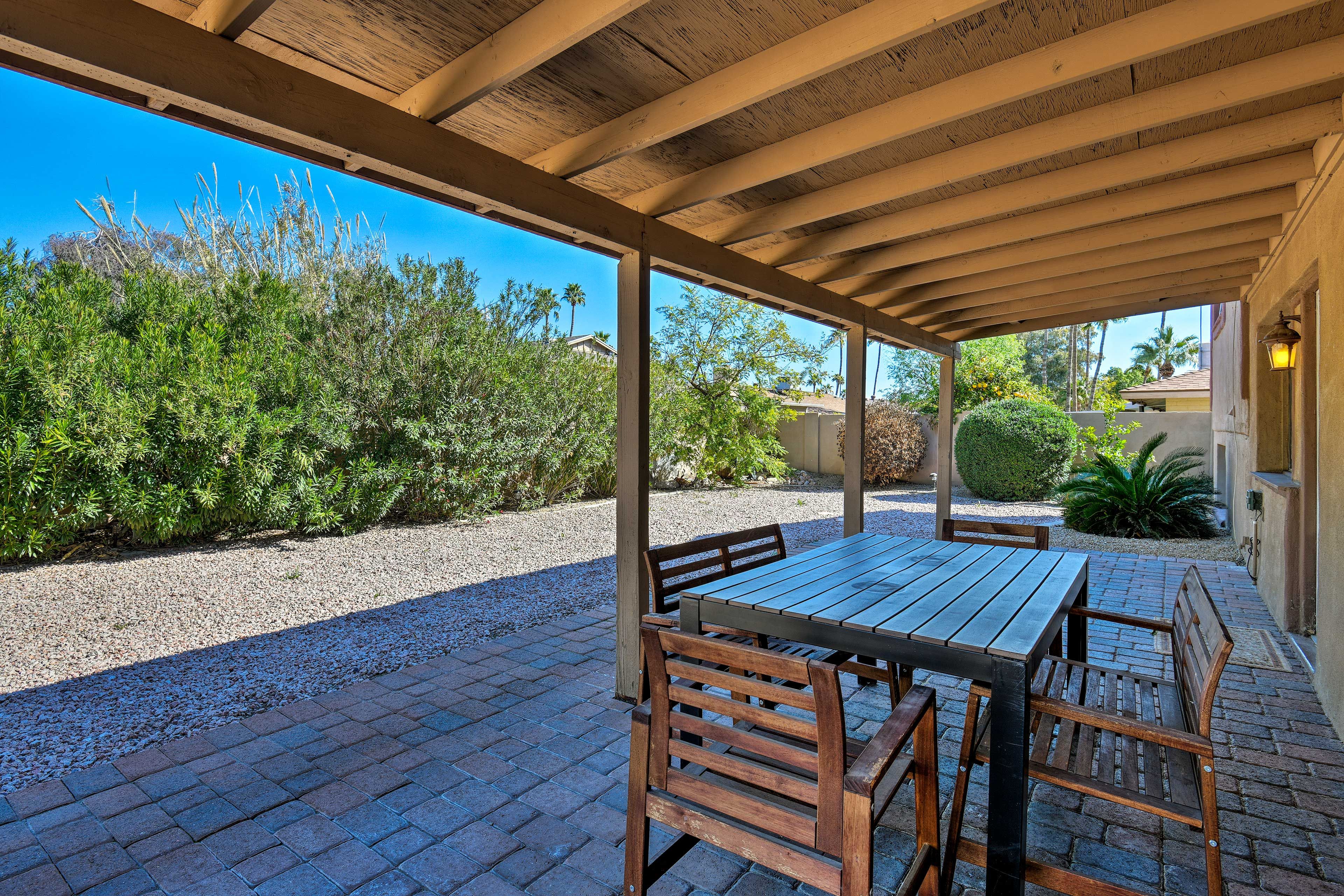 Enjoy al fresco dining on the covered patio behind the house.