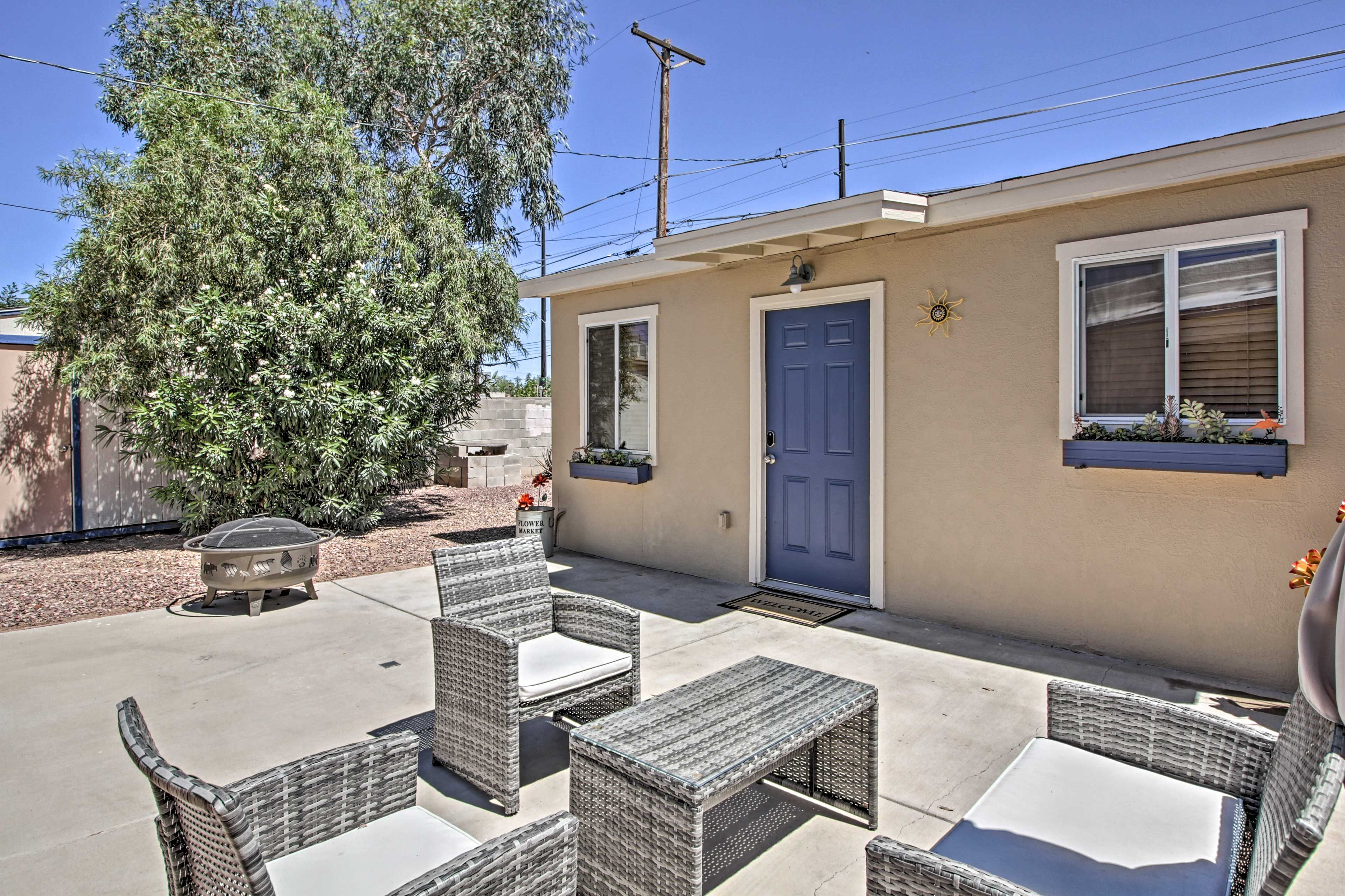The outdoor patio space boasts a gas grill, fire pit and shaded seating!