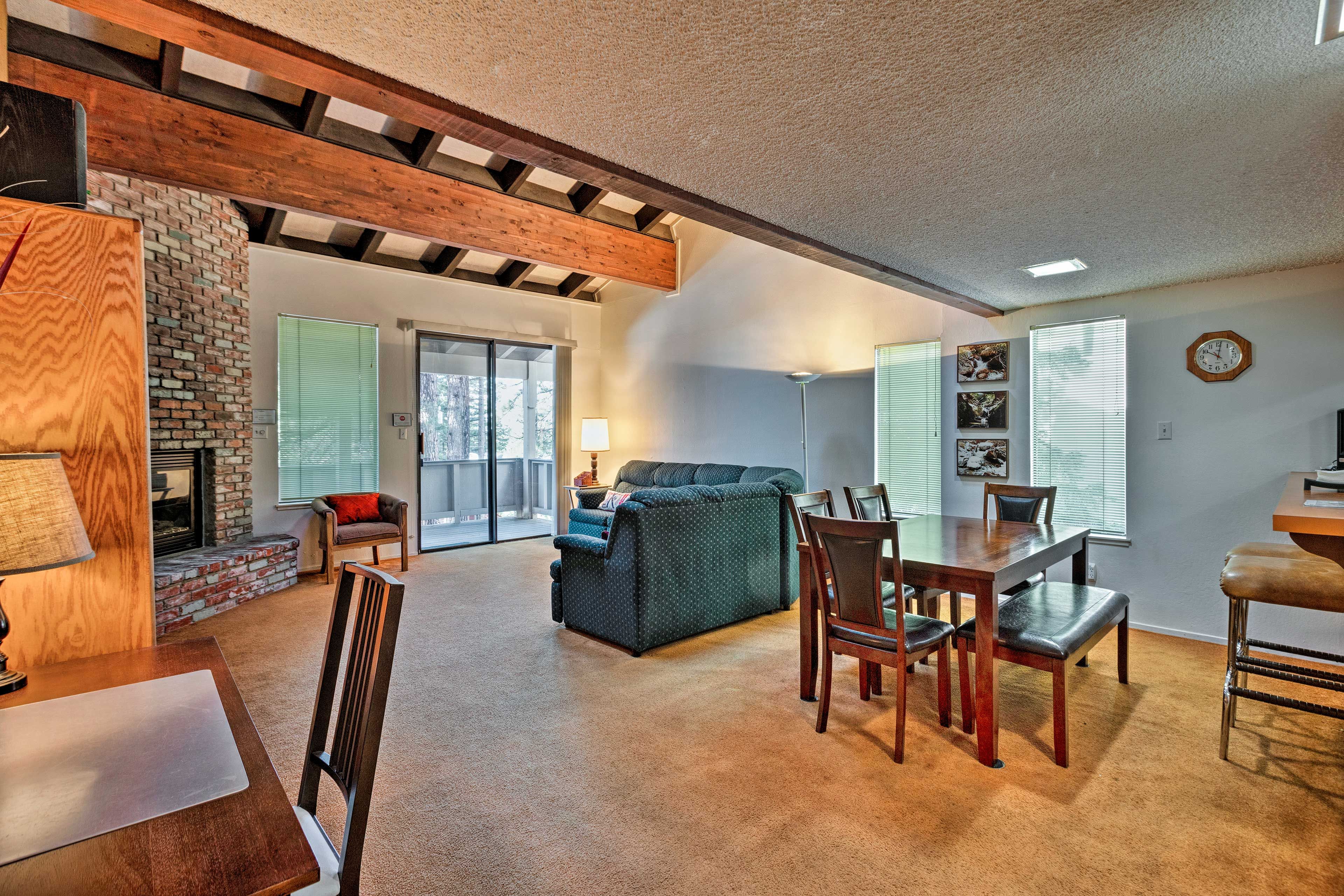 The living space includes a work space and dining table with room for 6.