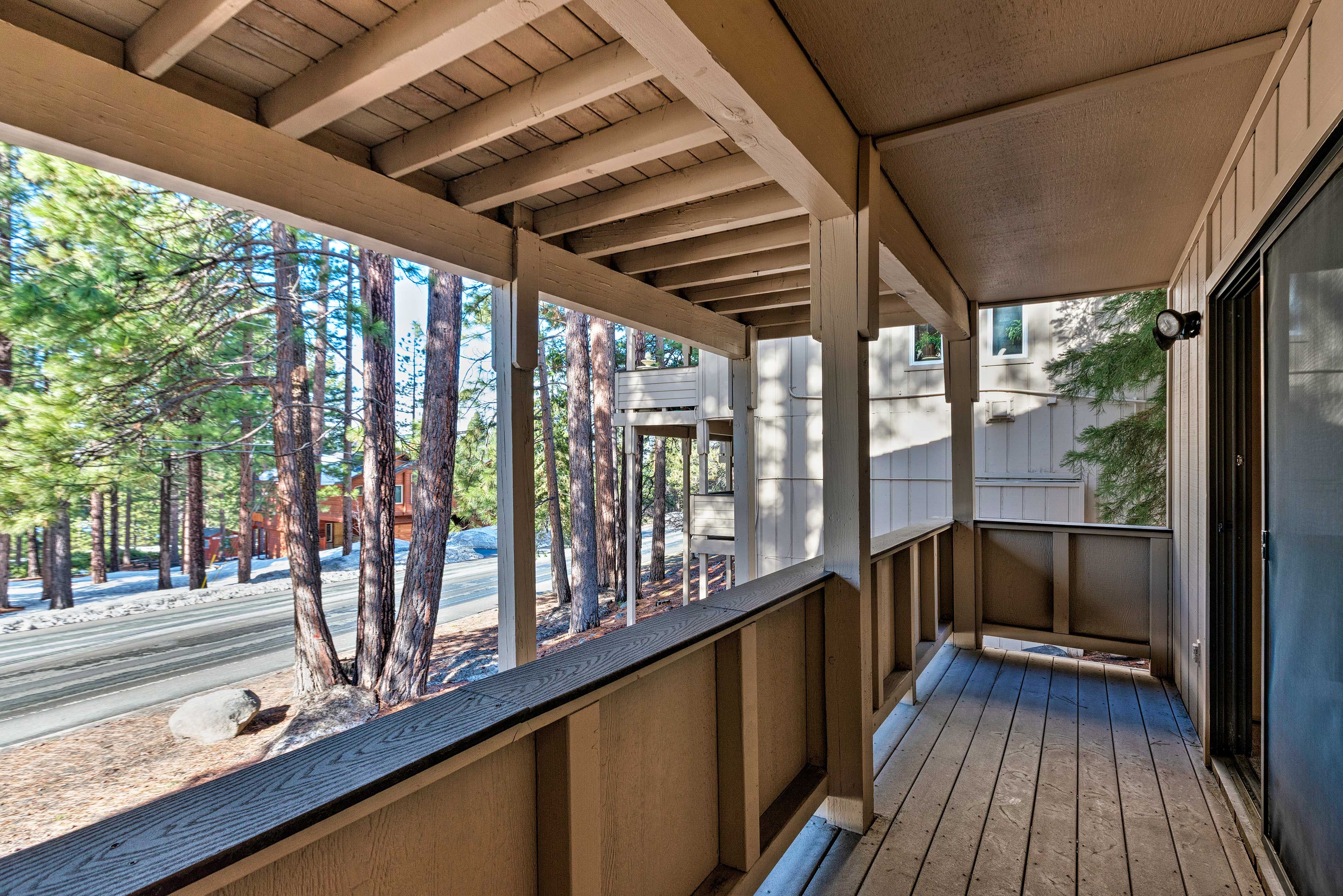 Enjoy the fresh air and wooded views from the deck.