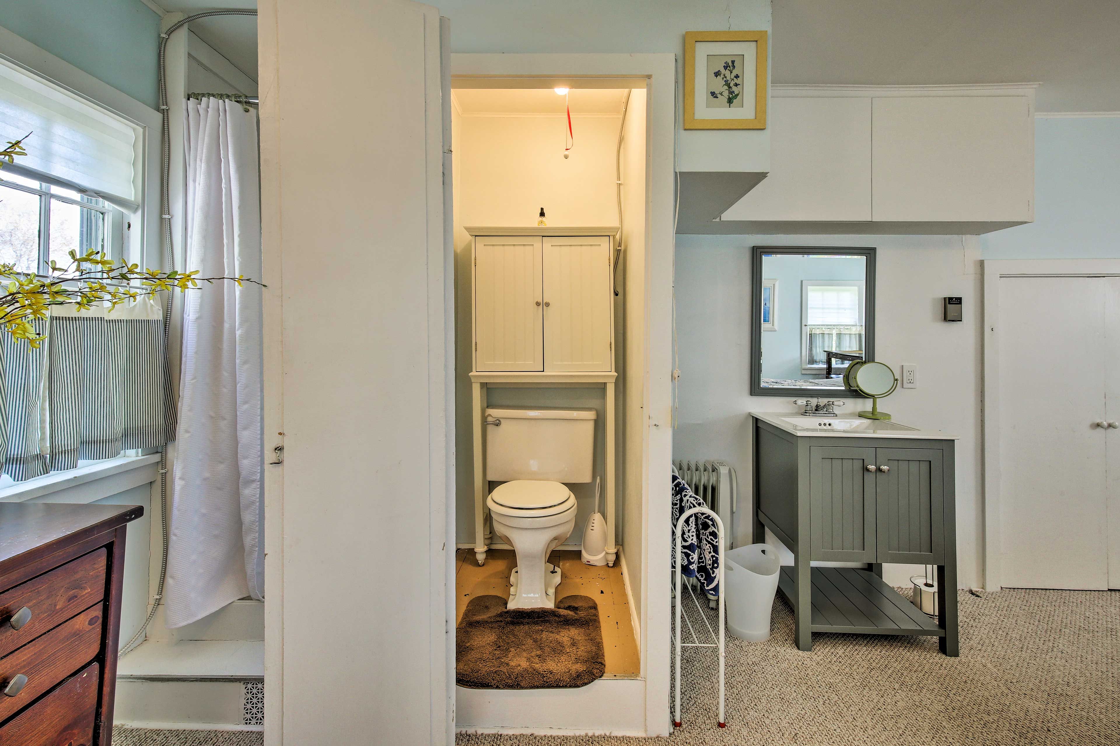 The bathroom boasts a shower tucked in the corner!