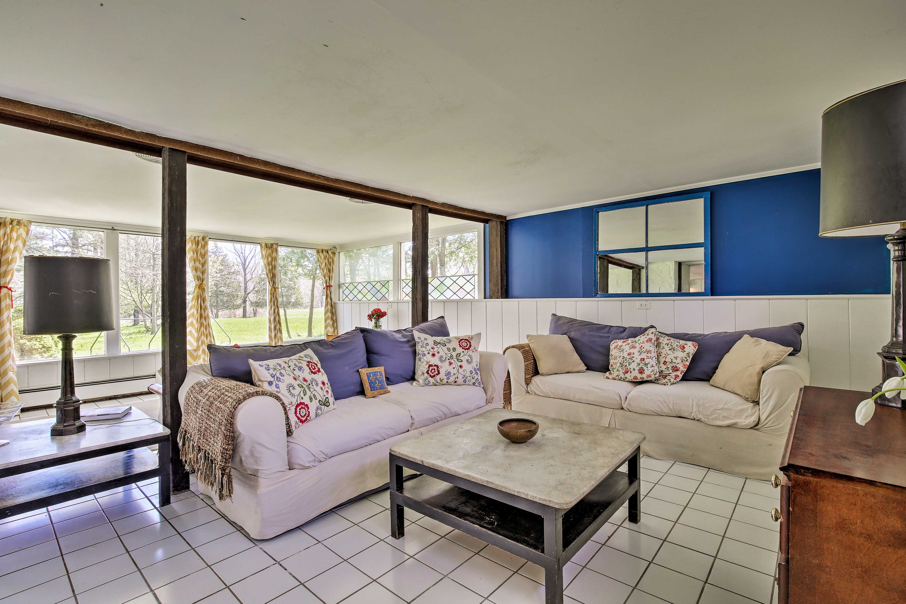 Vibrant accents and sunshine fill the living area.
