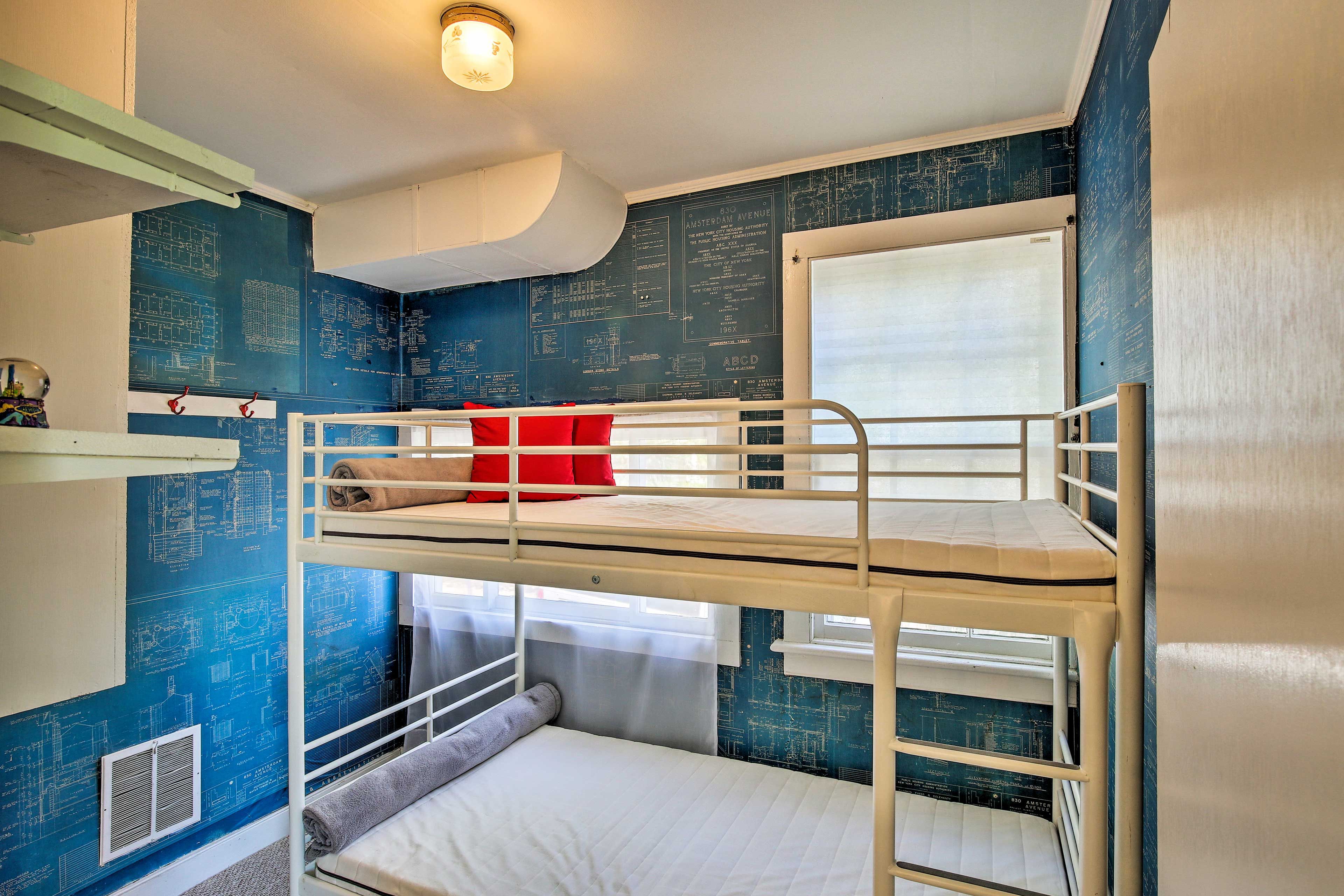 Kids will love the printed wallpaper and twin bunk bed in The Blue Print Room.