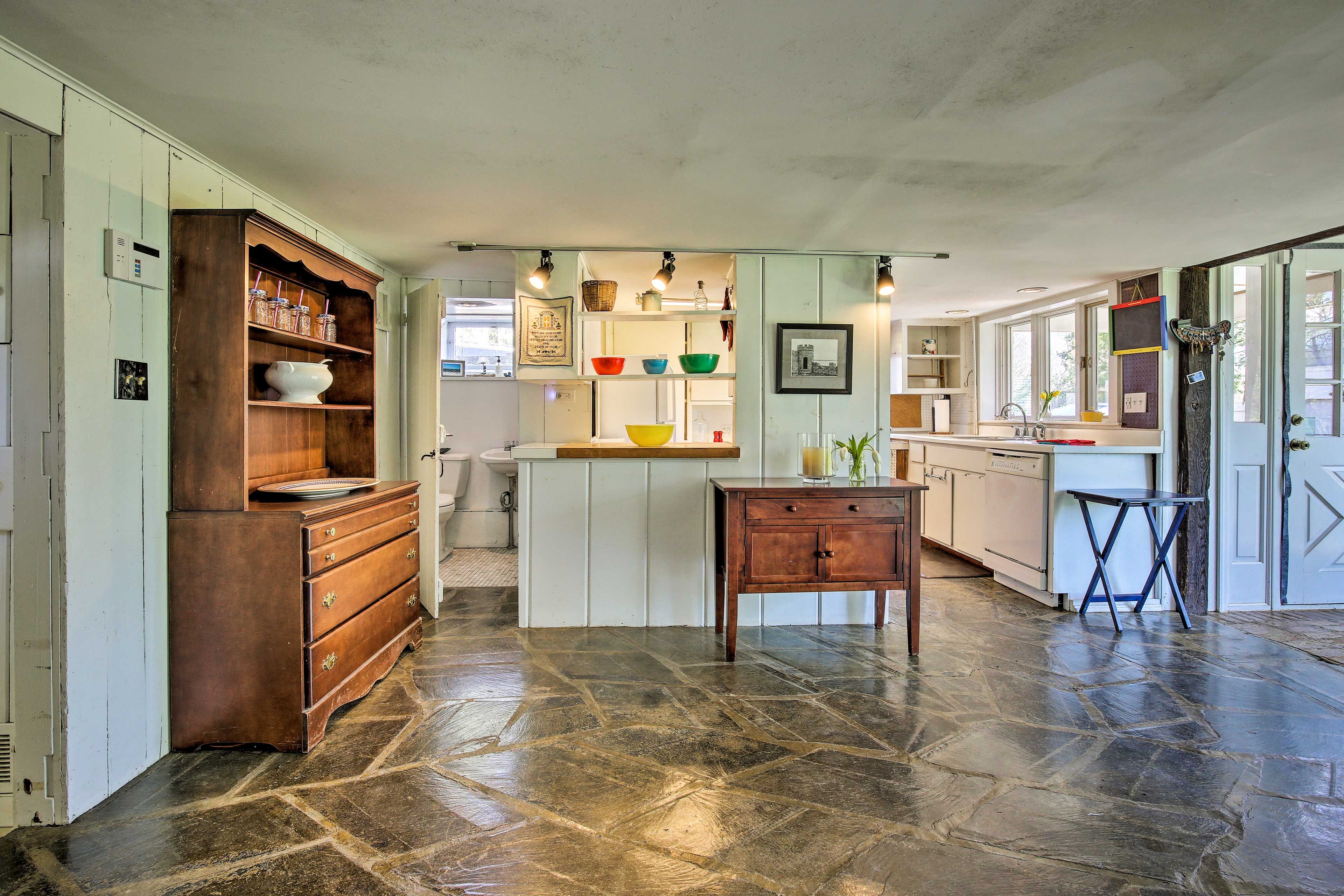 Antique furnishings rest on the flagstone floor.