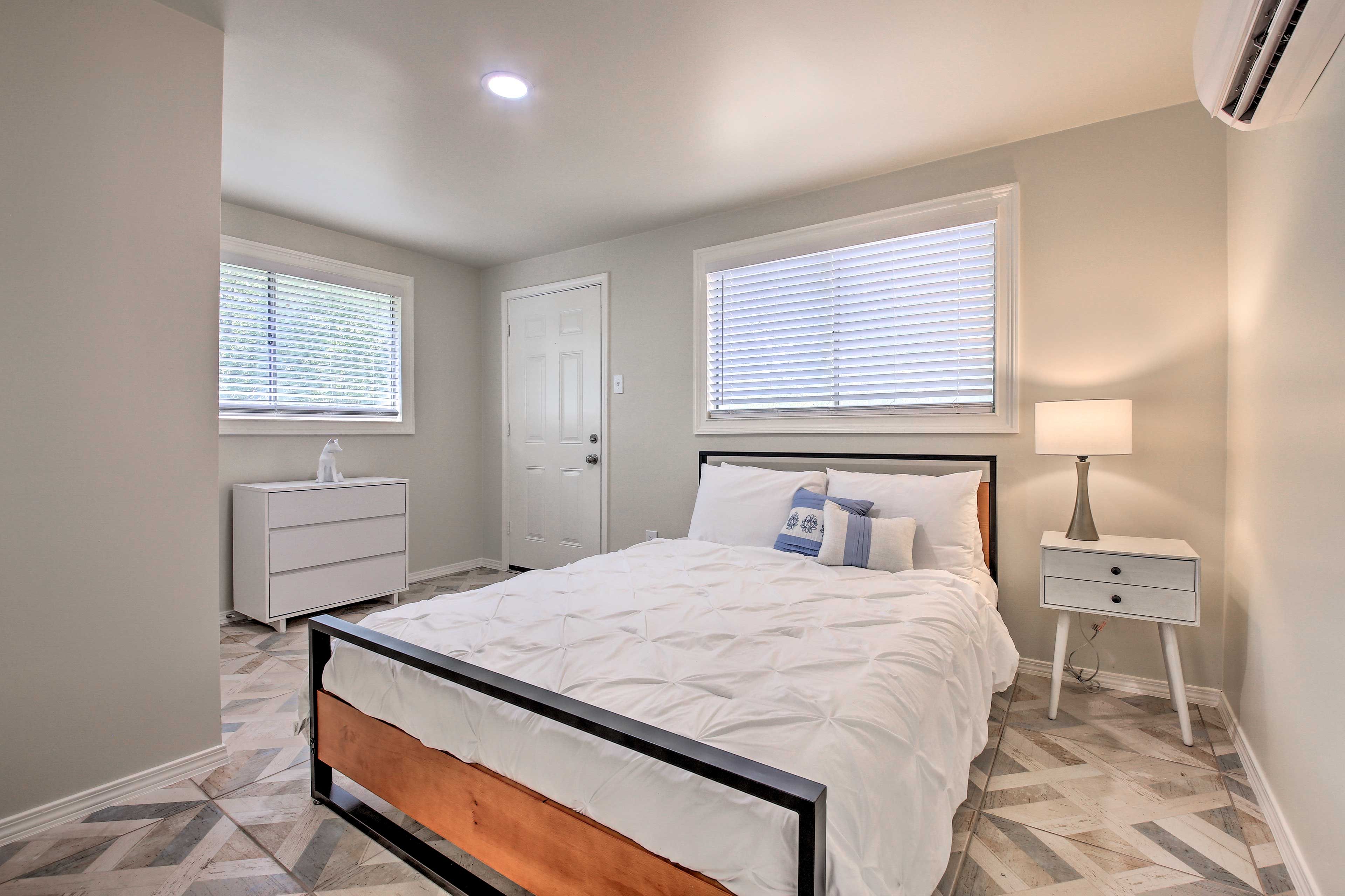 The bedroom is complete with a queen-sized bed.