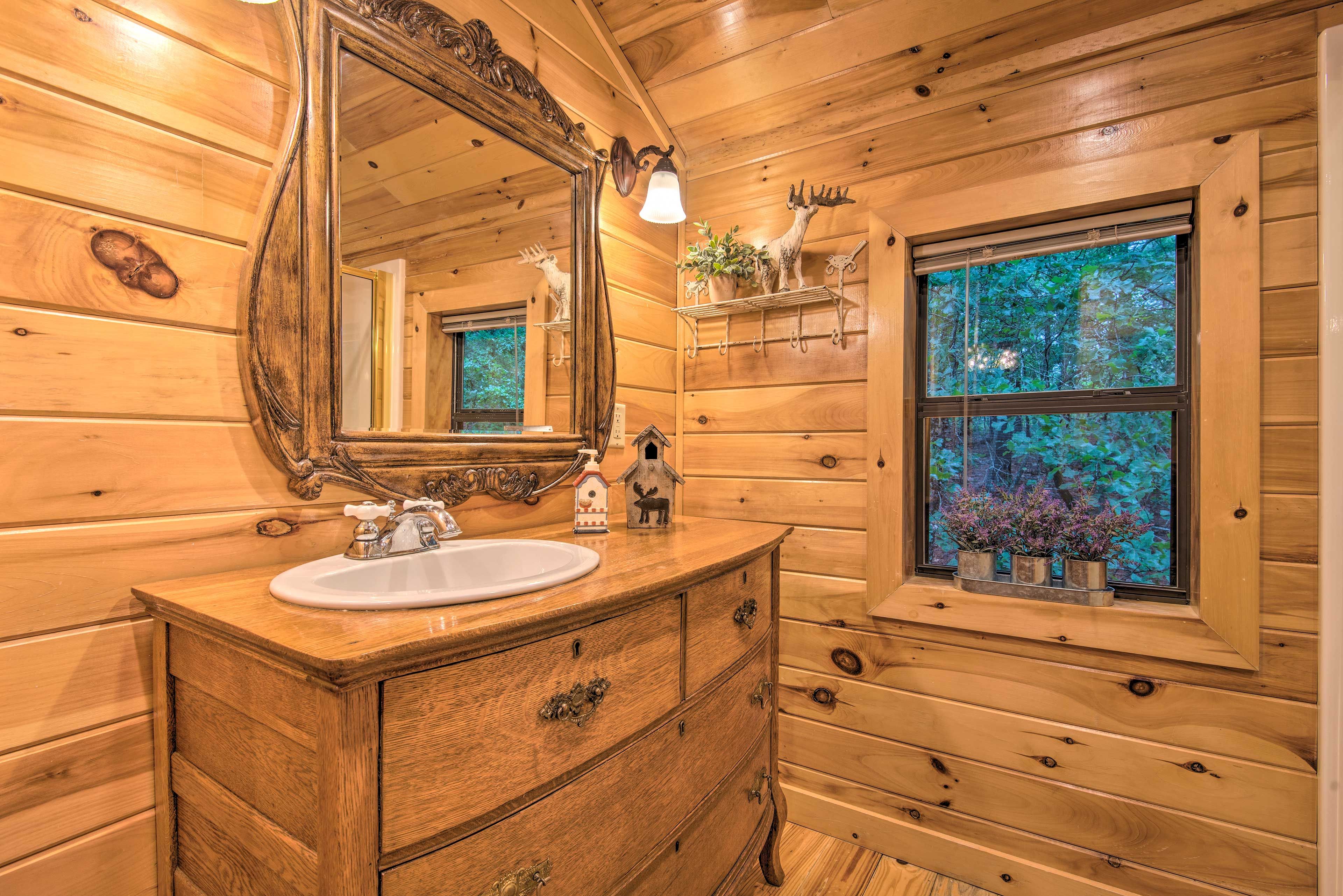 The en-suite bathroom has plenty of high-end wooden furnishings.
