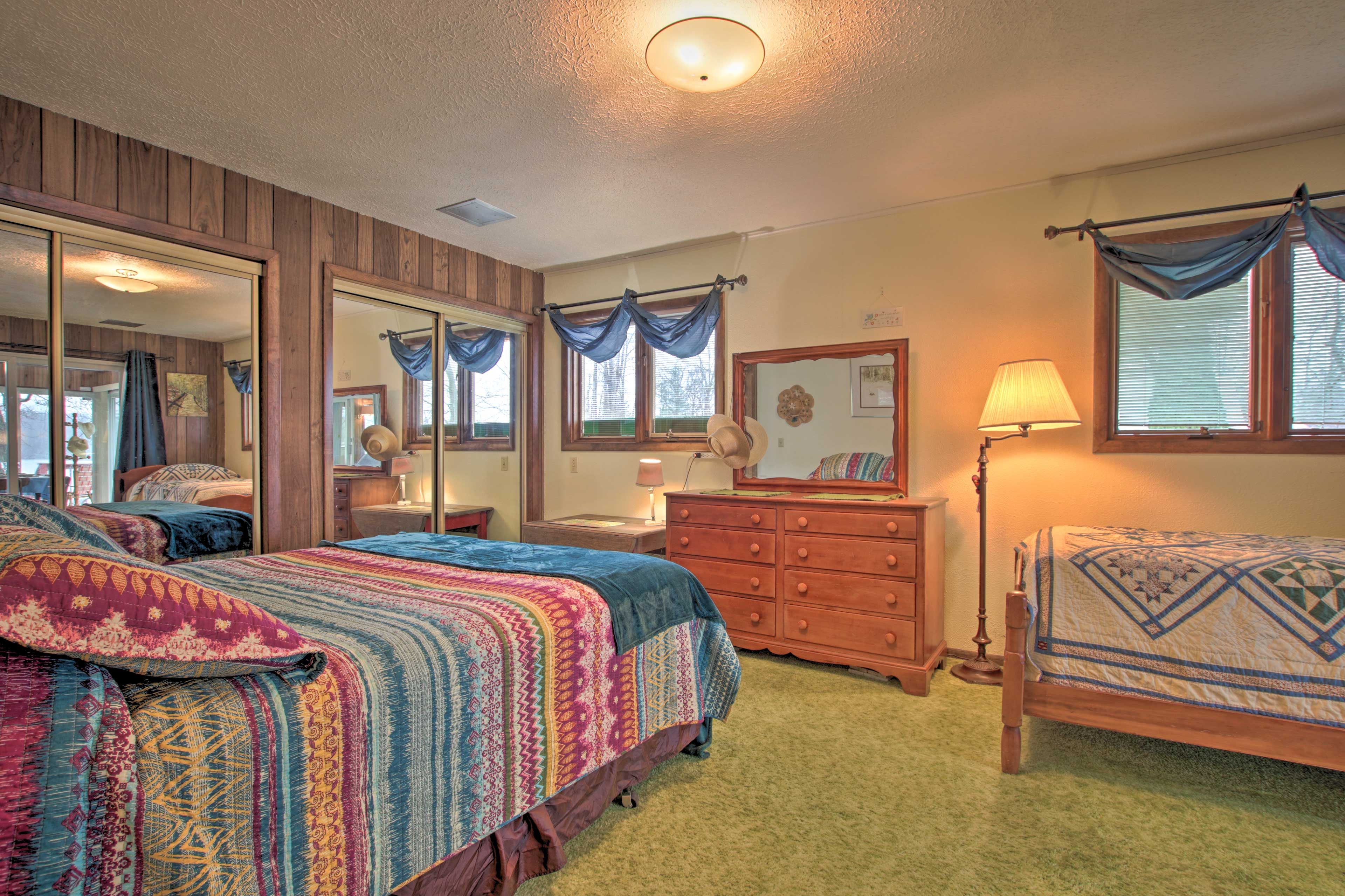 This bedroom features a queen and twin bed, along with ample storage space.