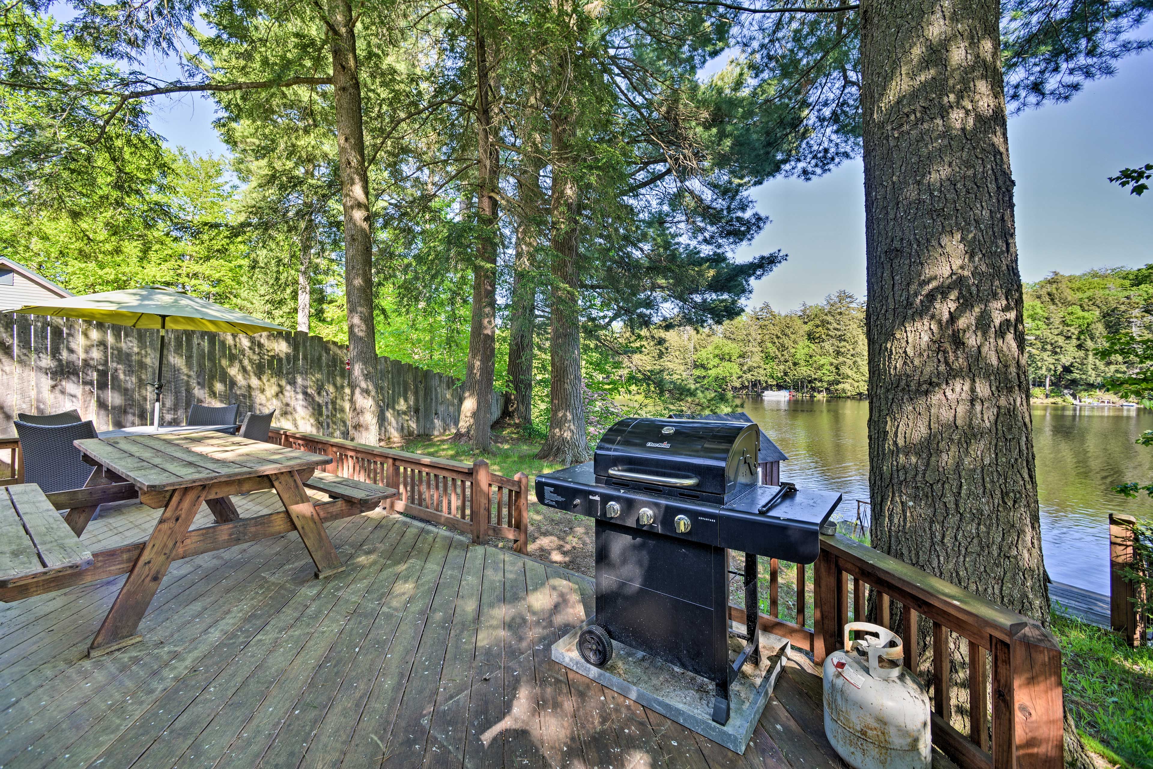 Out on the back deck, find a grill with ample outdoor dining seating!