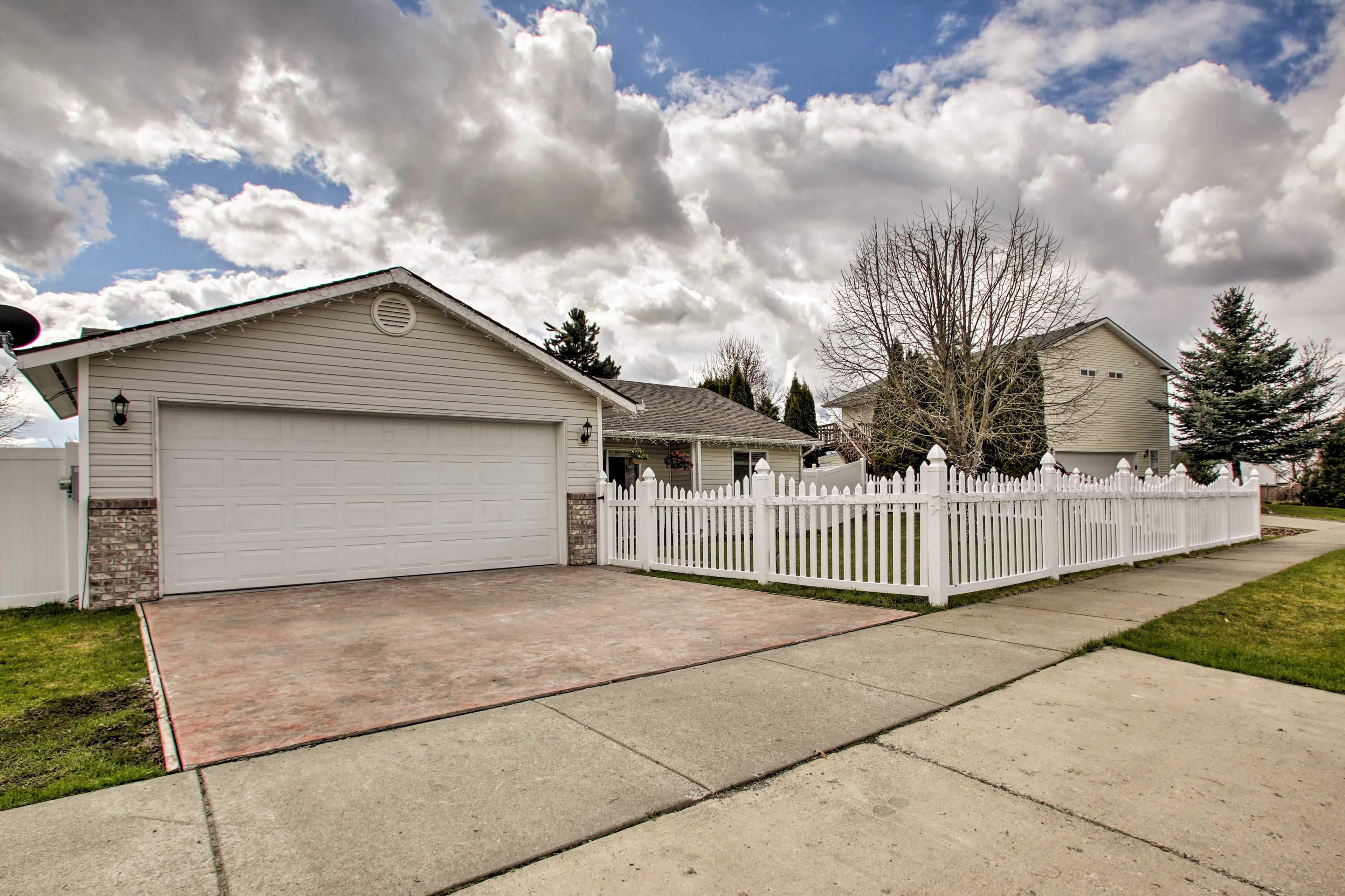 Two vehicles can park in the driveway.