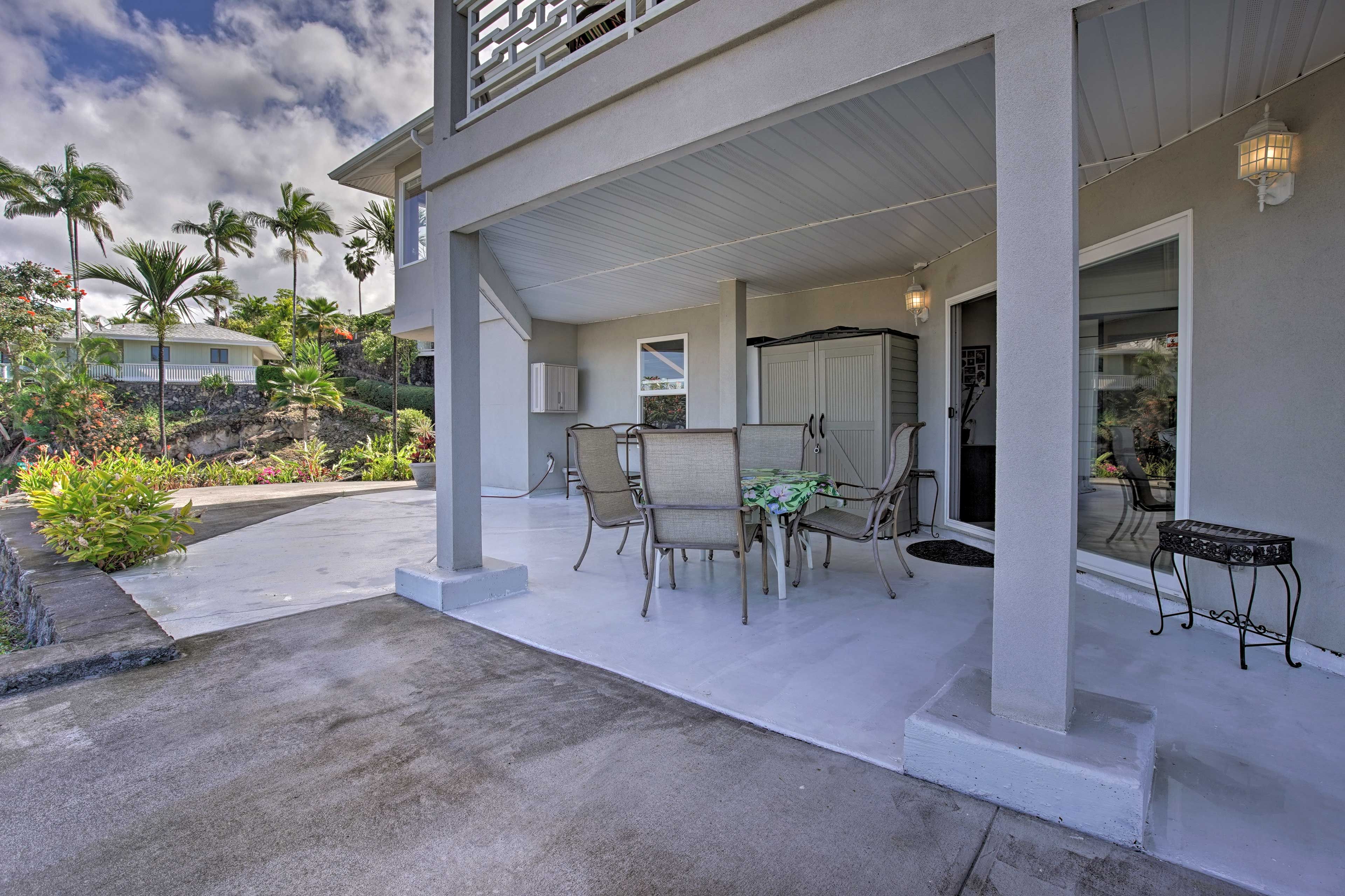 The spacious lower lanai offers lush views of the surrounding landscape.