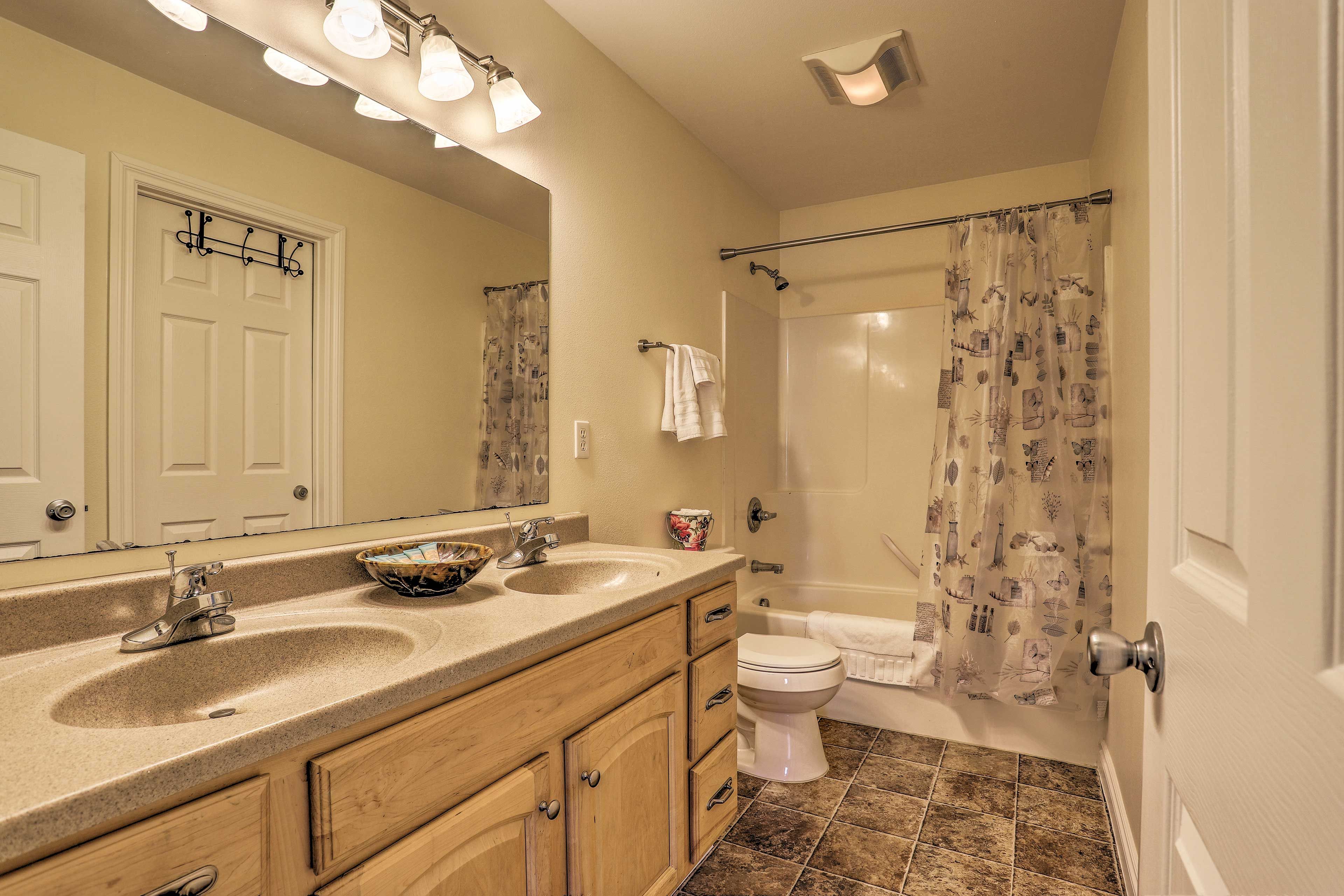 Double sinks and a shower/tub combo complete the full bathroom.