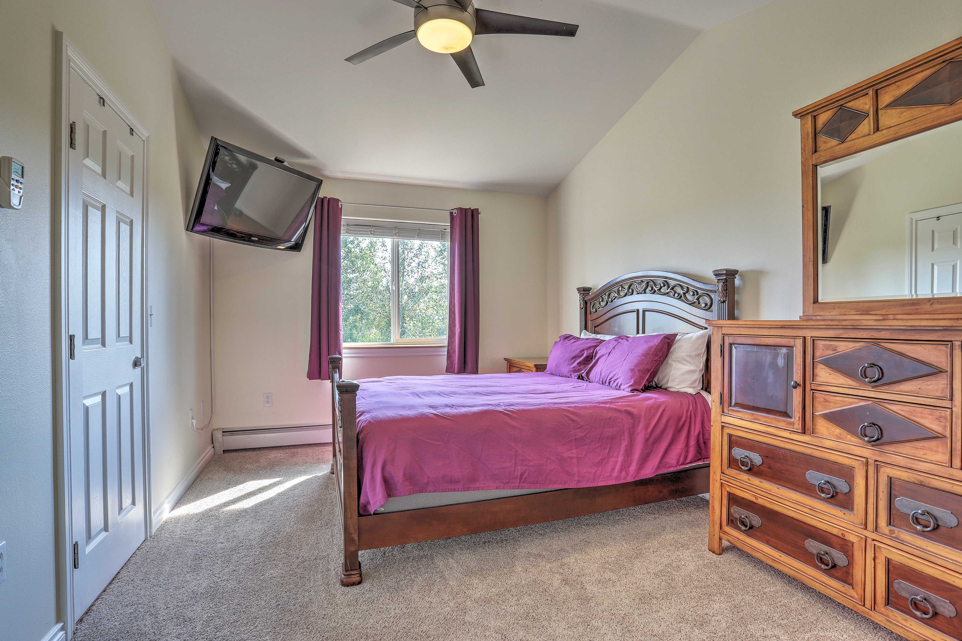 The carved wooden bed faces the flat-screen cable TV.