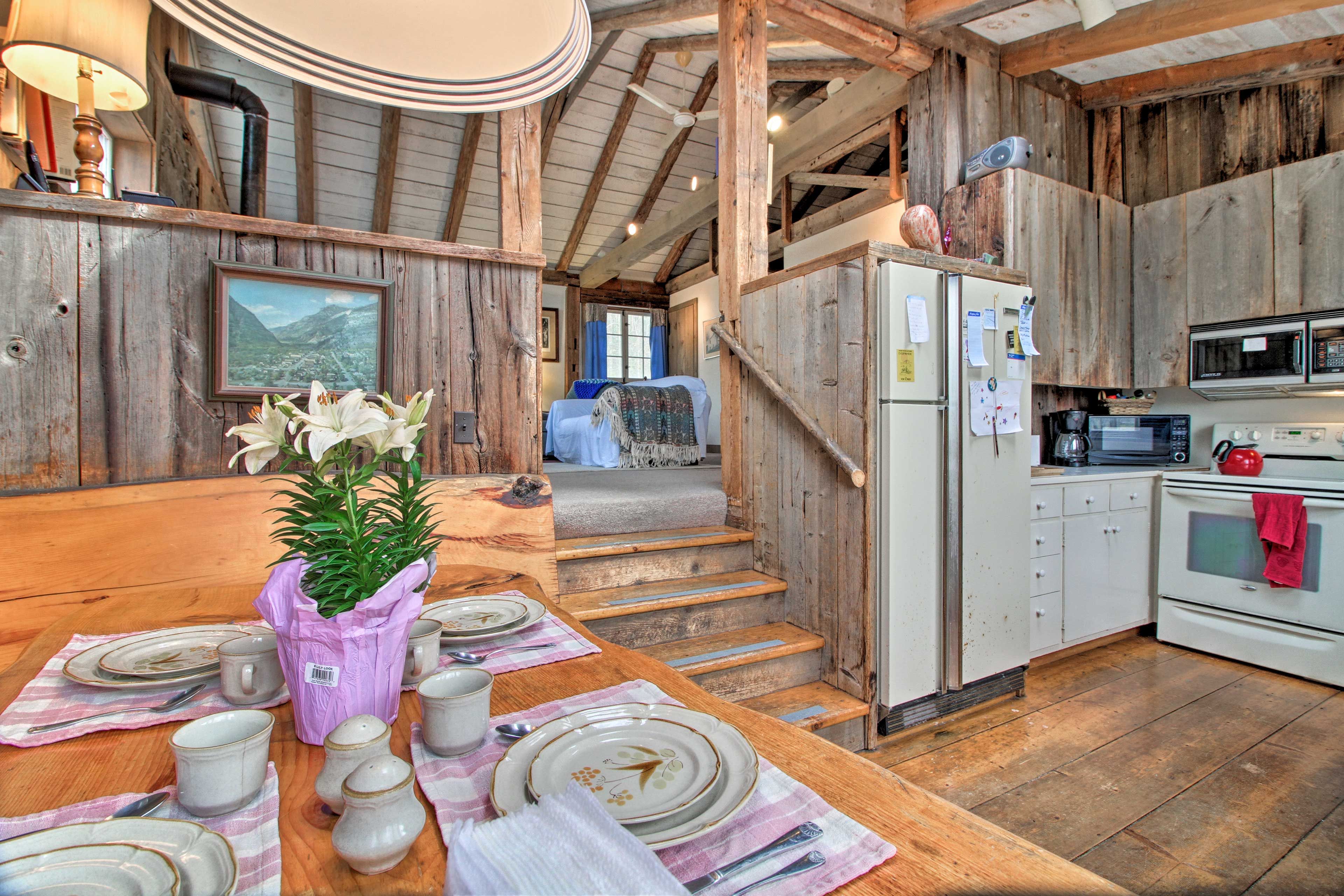Wood & stone walls create a rustic atmosphere in this 3-bedroom, 2-bath home.