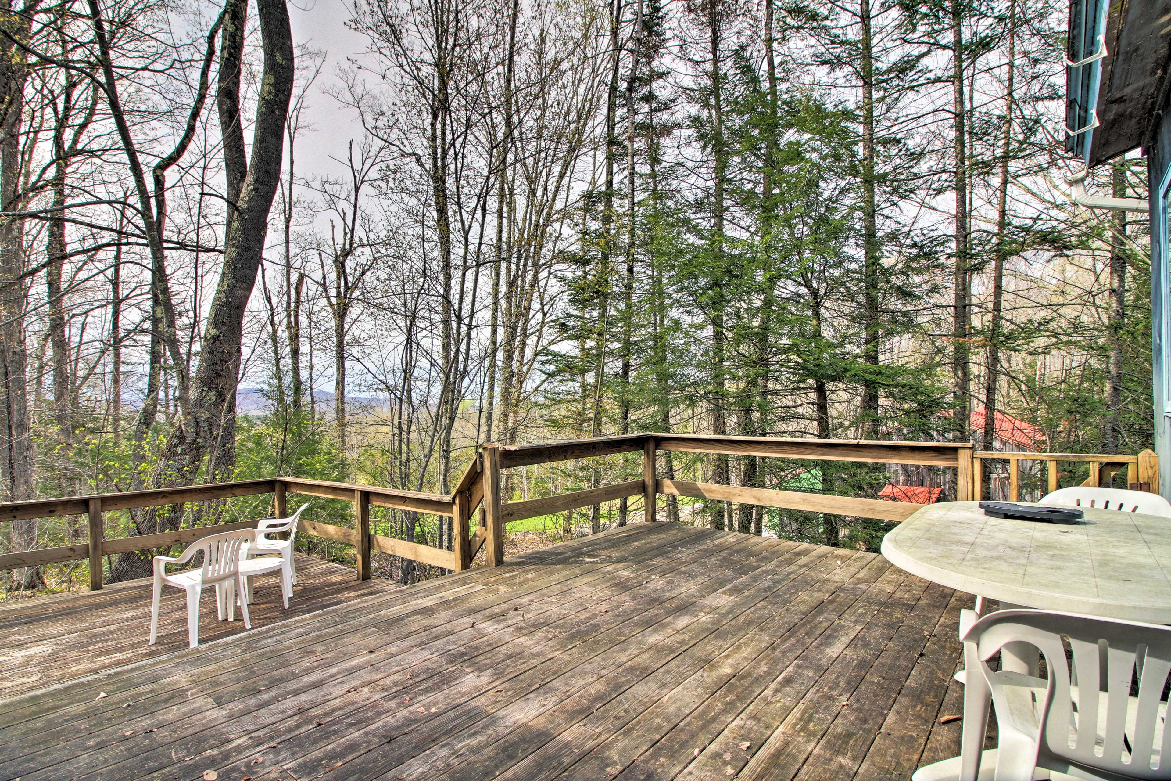 The vacation rental boasts a spacious deck complete with distant mountain views!