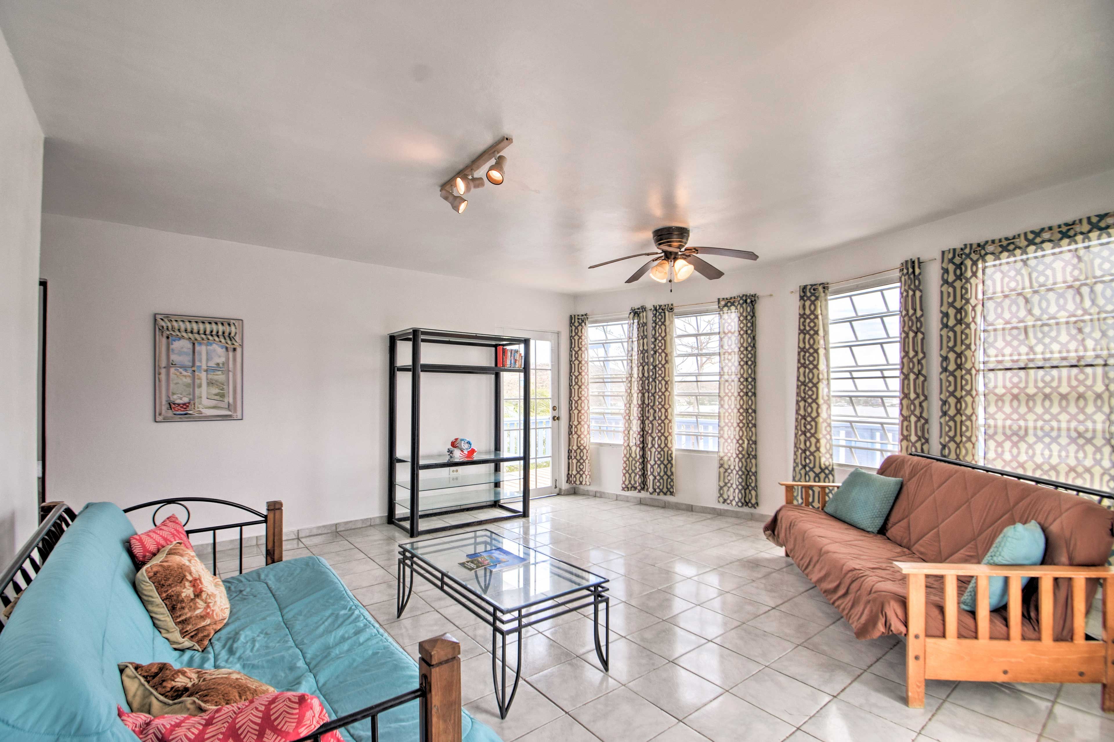 Unwind in the bright living space featuring tile floors and large windows.