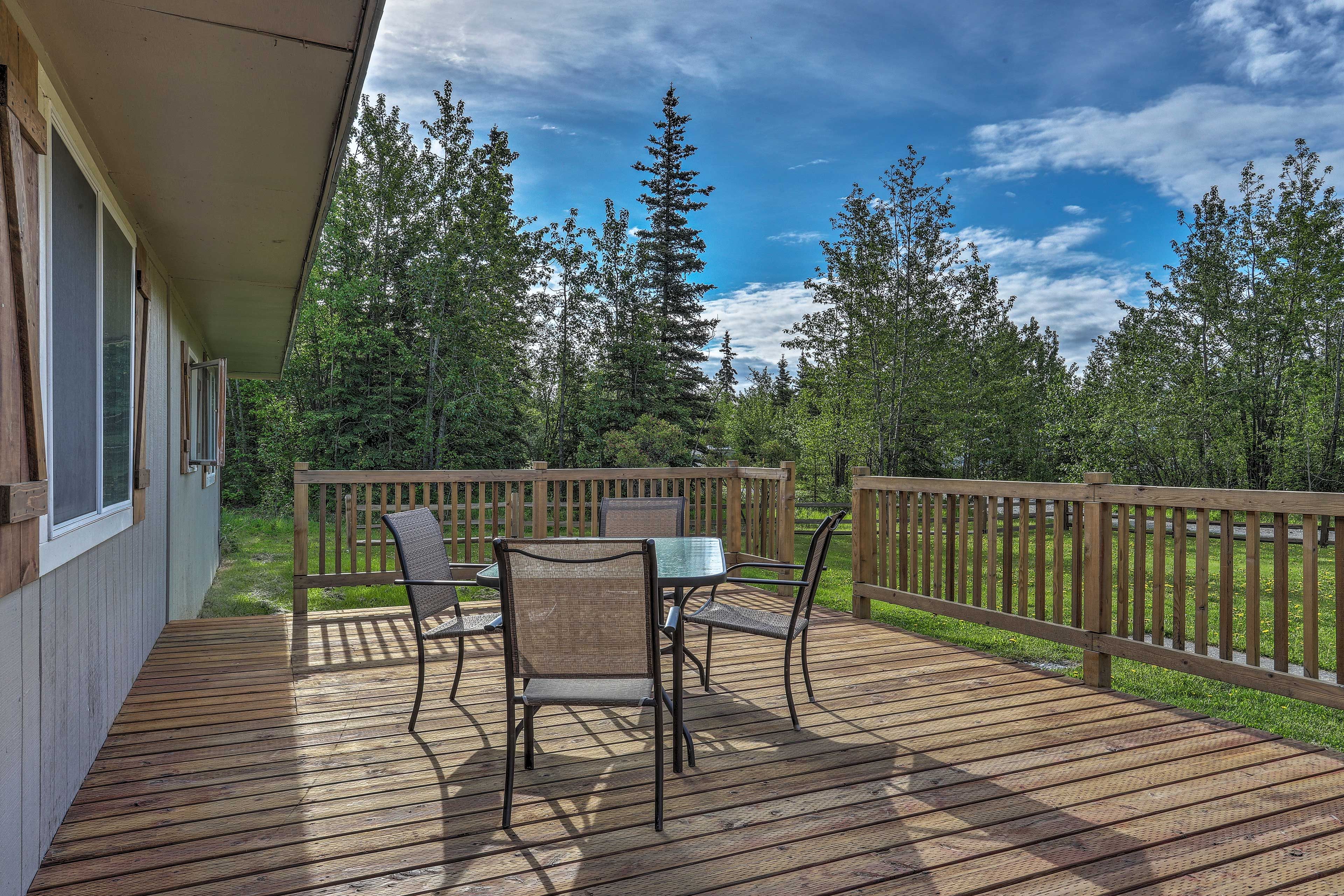 Surrounded by serenity, the deck features seating for 4 at the table.