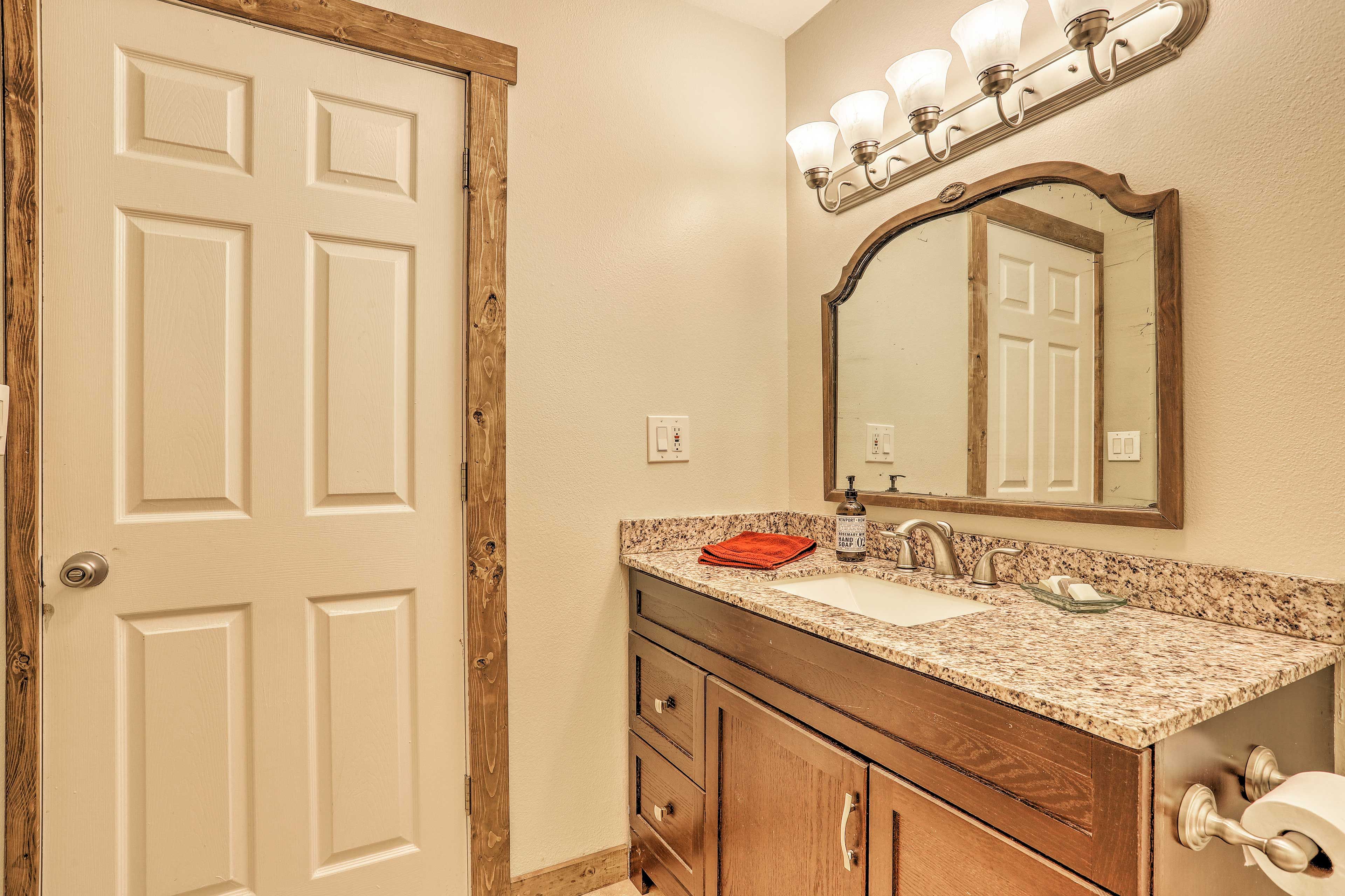 This full bathroom boasts granite counters.