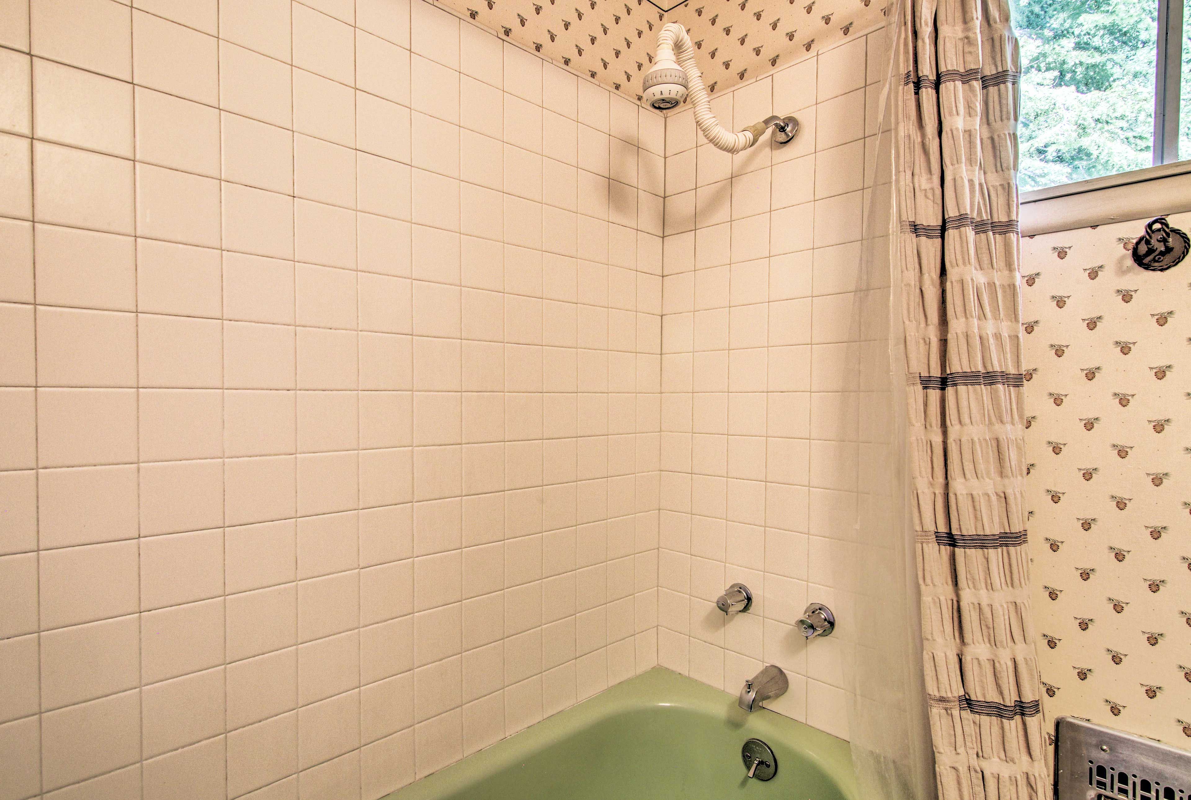 A shower/tub combo highlights this bedroom.