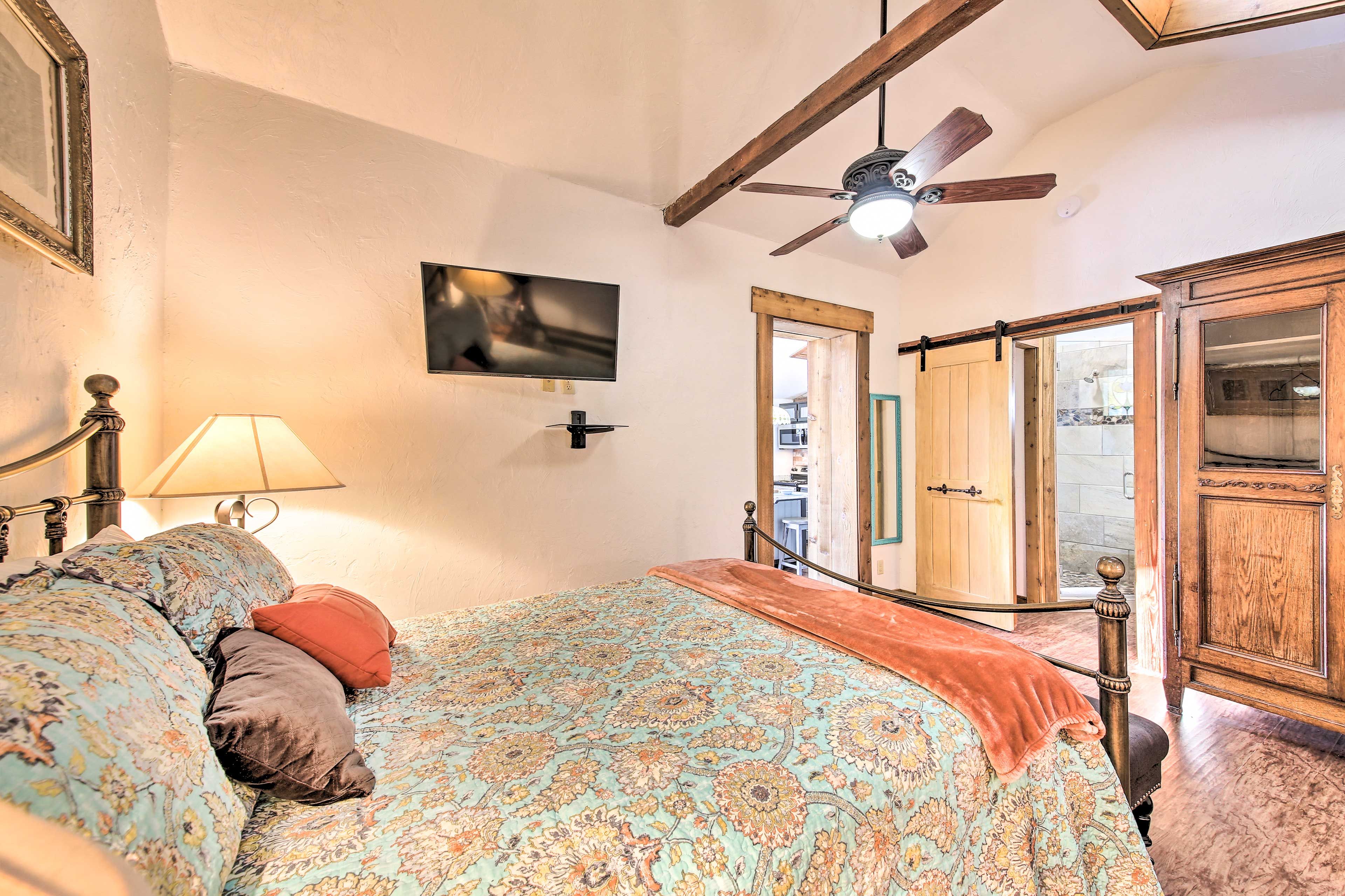 Snuggle up in bed to stream a show on the Smart TV.